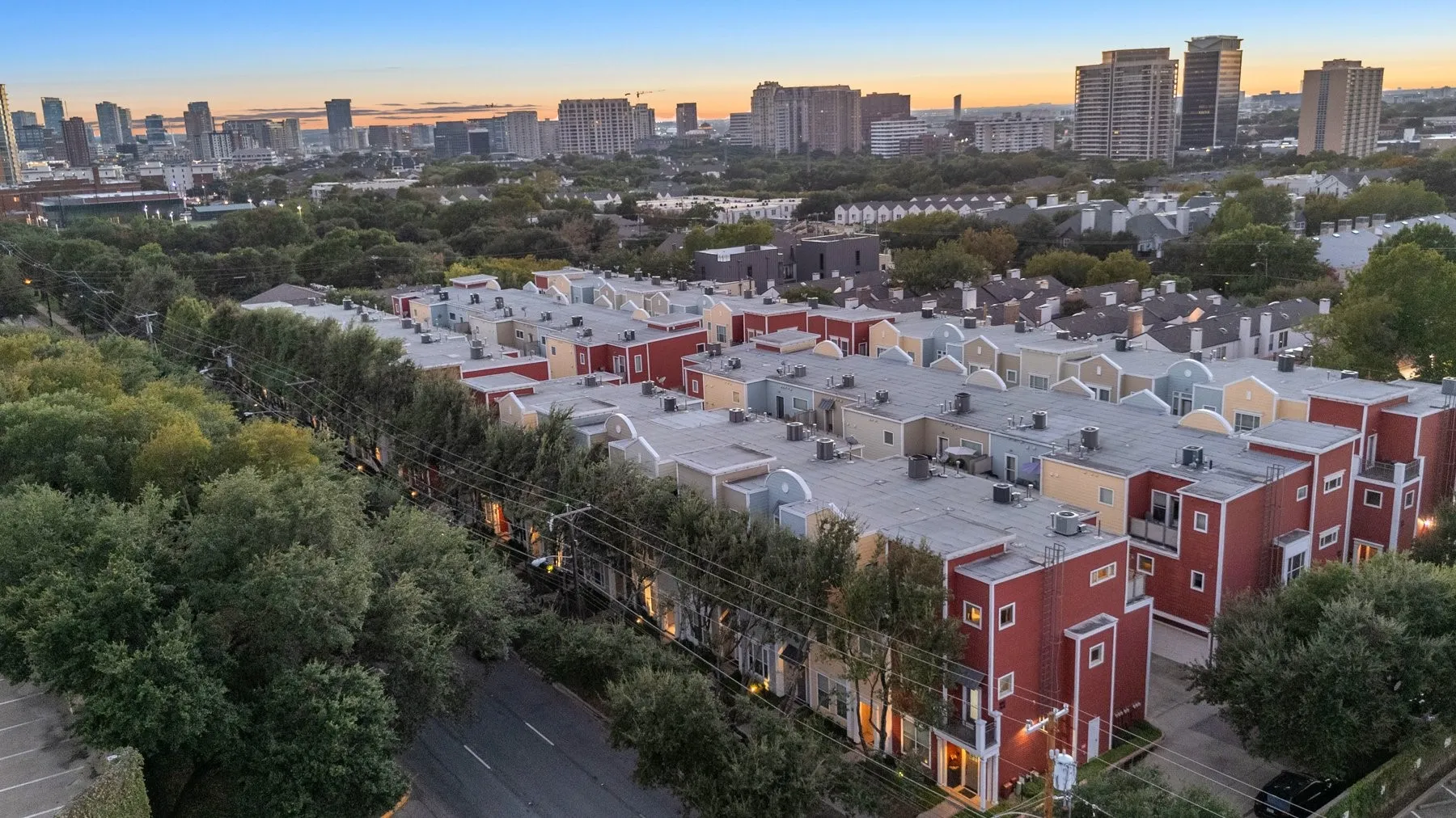 Aerial view of the community with the downtown Dallas skyline at sunset
