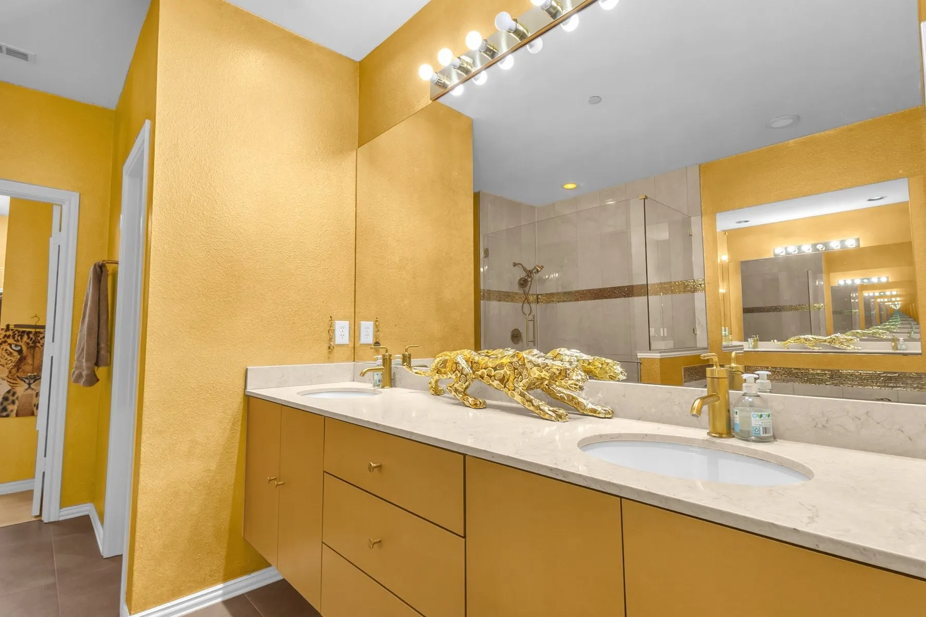 Primary bath vanity with light-colored counters and ample drawer storage