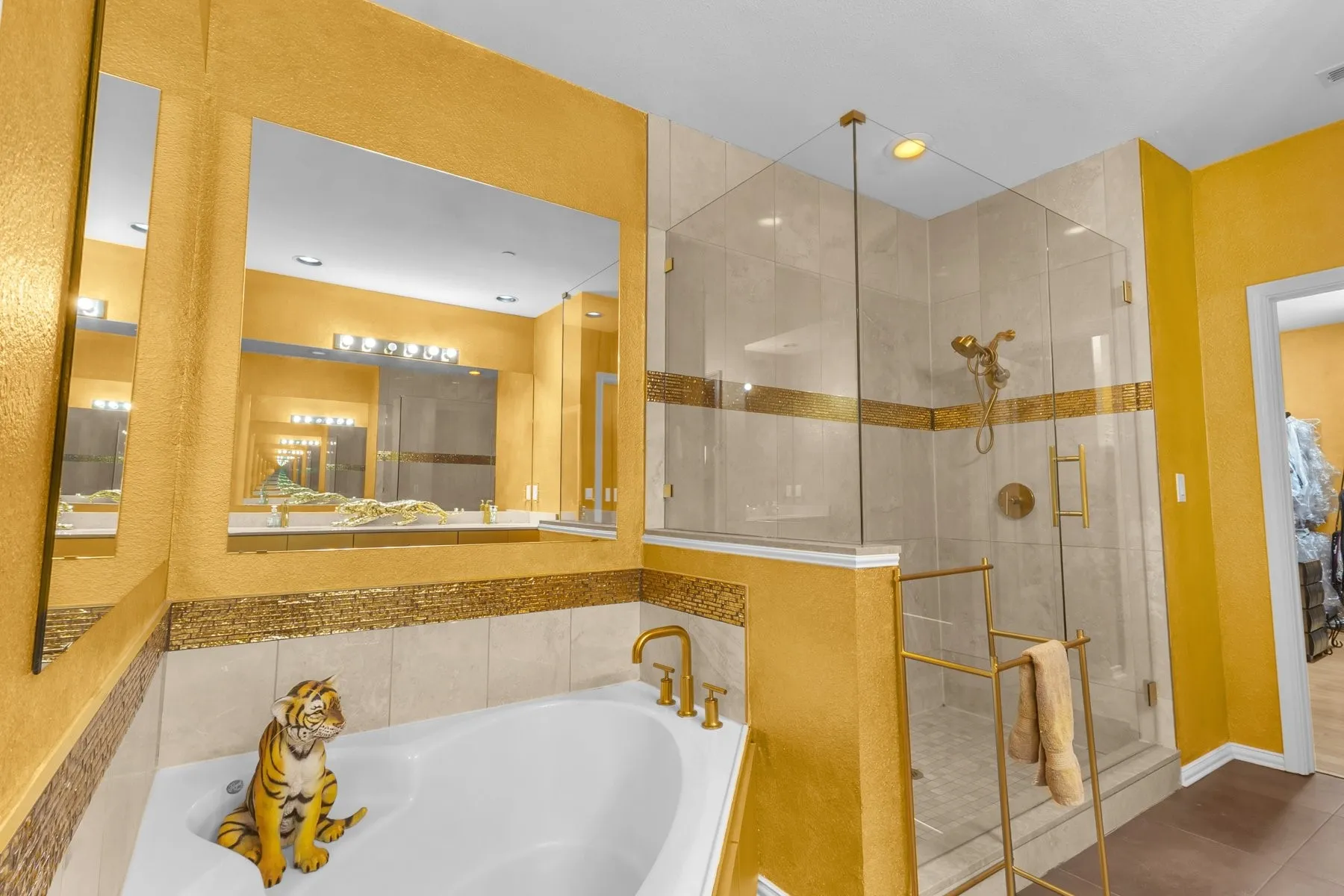 Corner soaking tub beside the walk-in shower in the primary bath