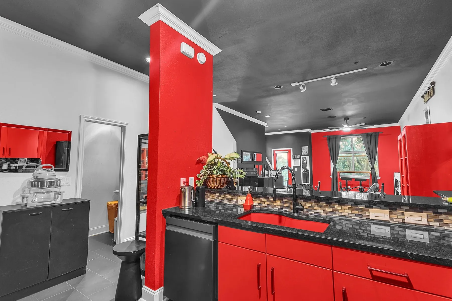 Kitchen peninsula with undermount sink, dishwasher and views across the open living space