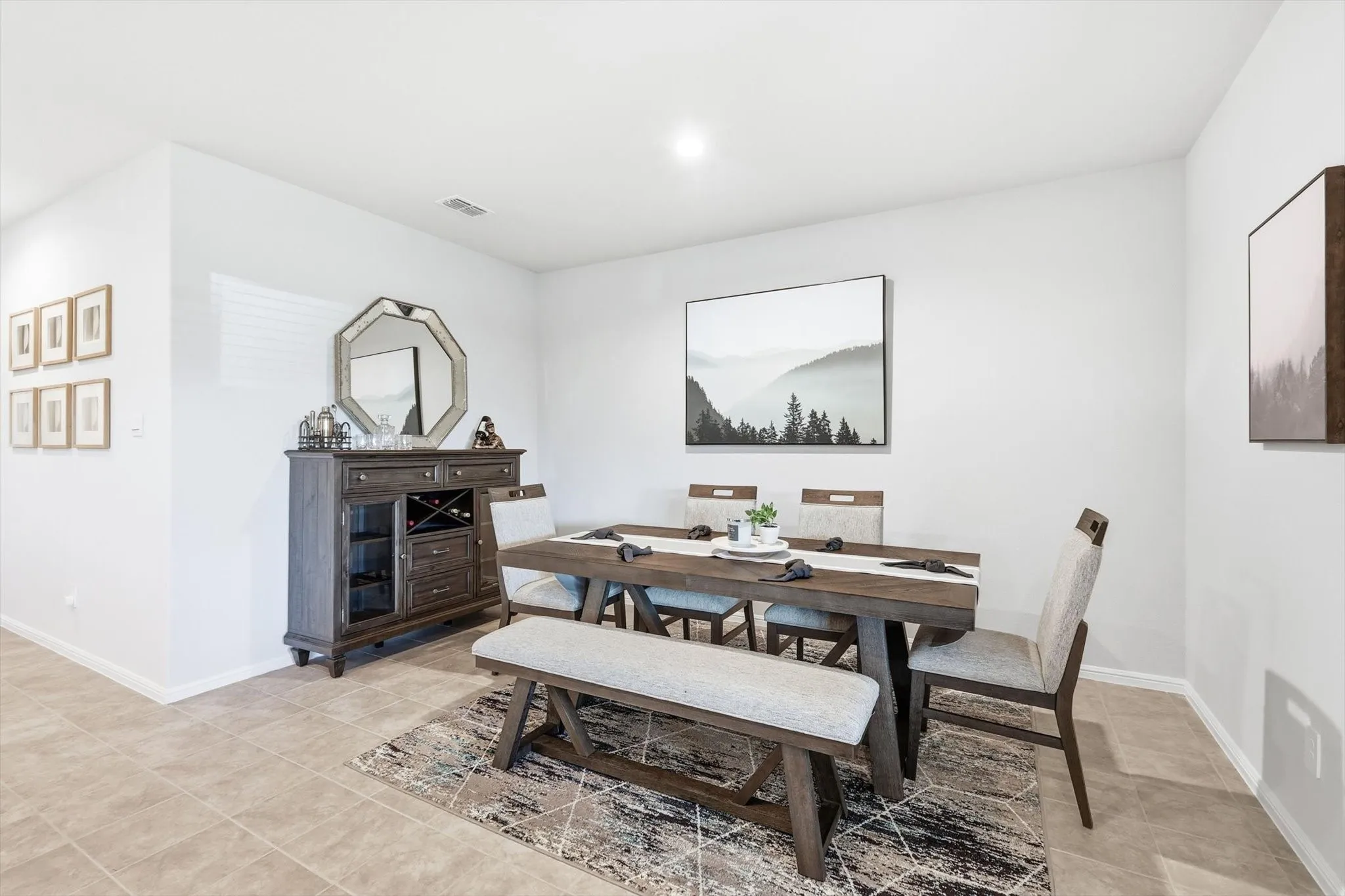 Recessed ceiling lighting illuminates the tiled flooring and neutral wall tones