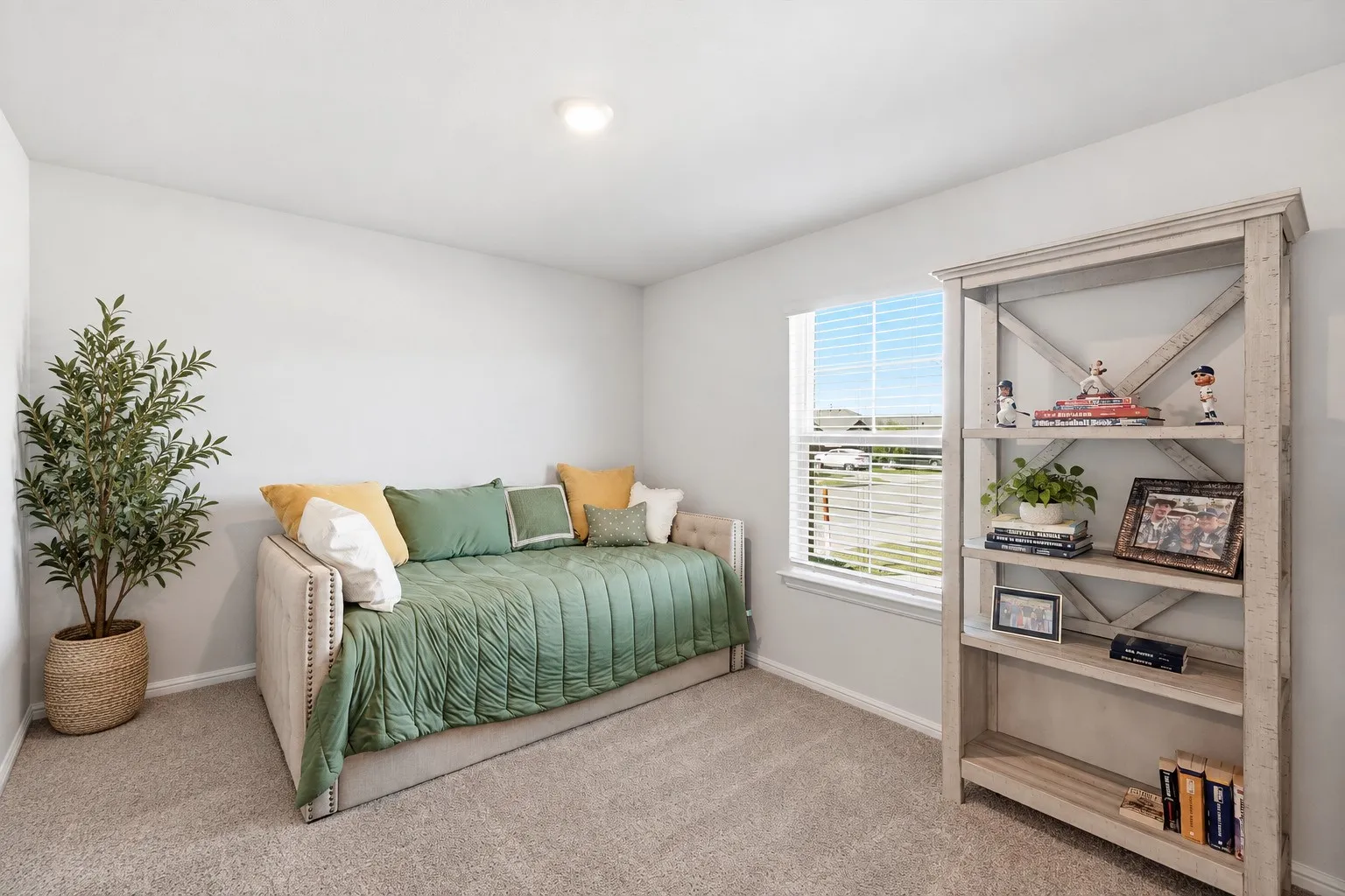 Recessed ceiling light, neutral wall paint, carpeted flooring, and a large window with horizontal blinds