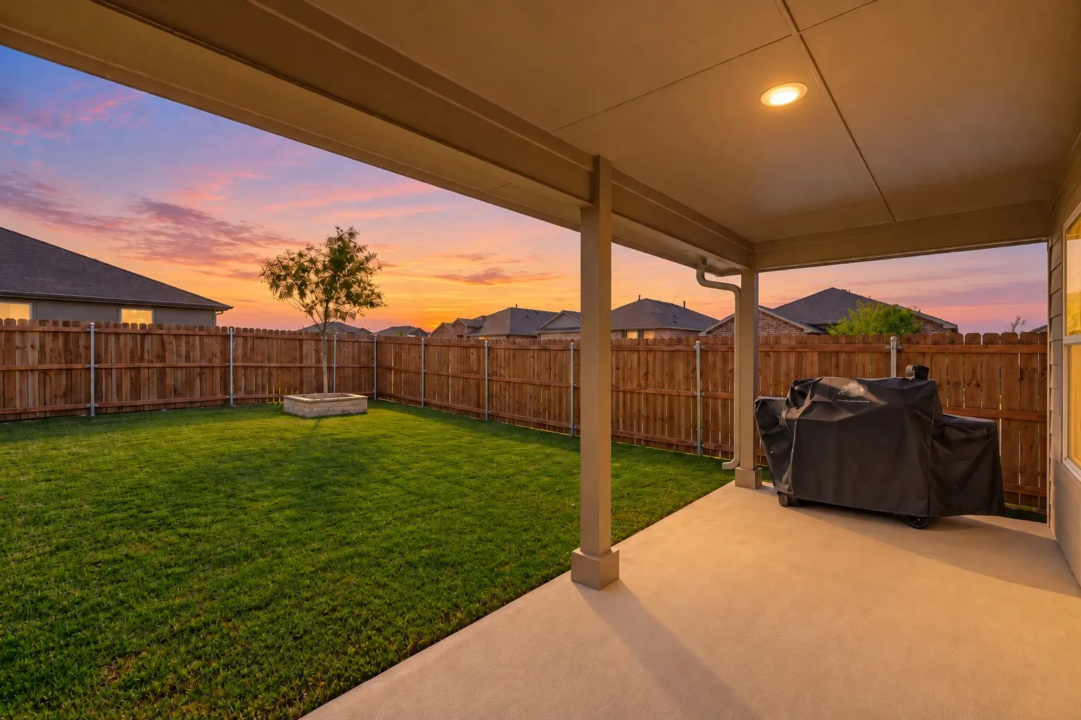 Covered patio with recessed lighting, concrete flooring, and a stone fire pit