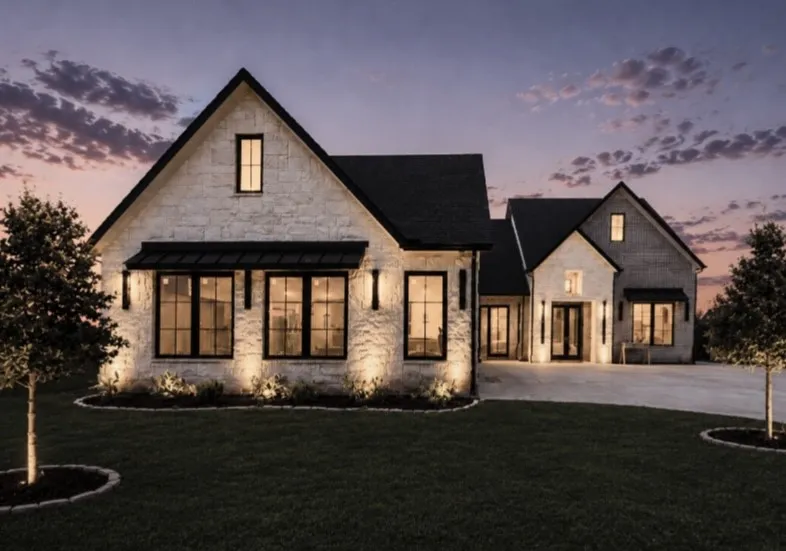Stone exterior with a black roof, large windows, and a prominent front entrance