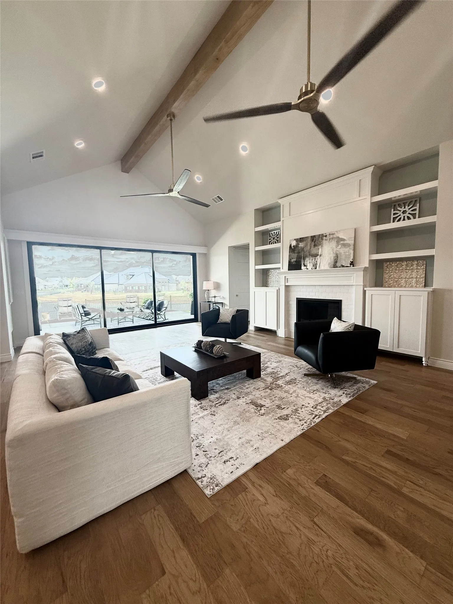 Vaulted ceiling with exposed wood beam, recessed lighting, and wood-finish flooring