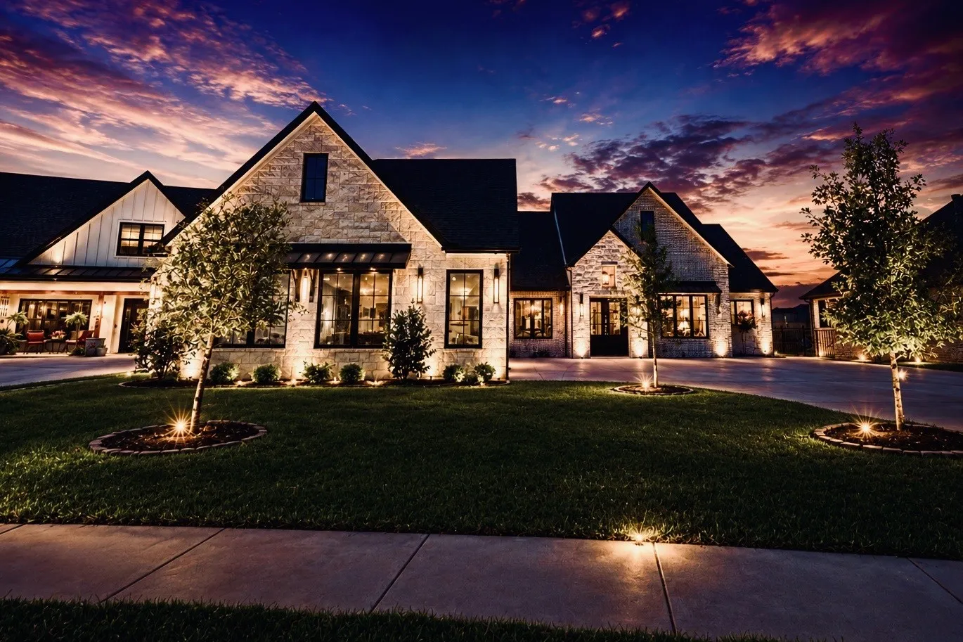 Stone exterior with dark trim windows, multi-gabled roofline, and established landscaping