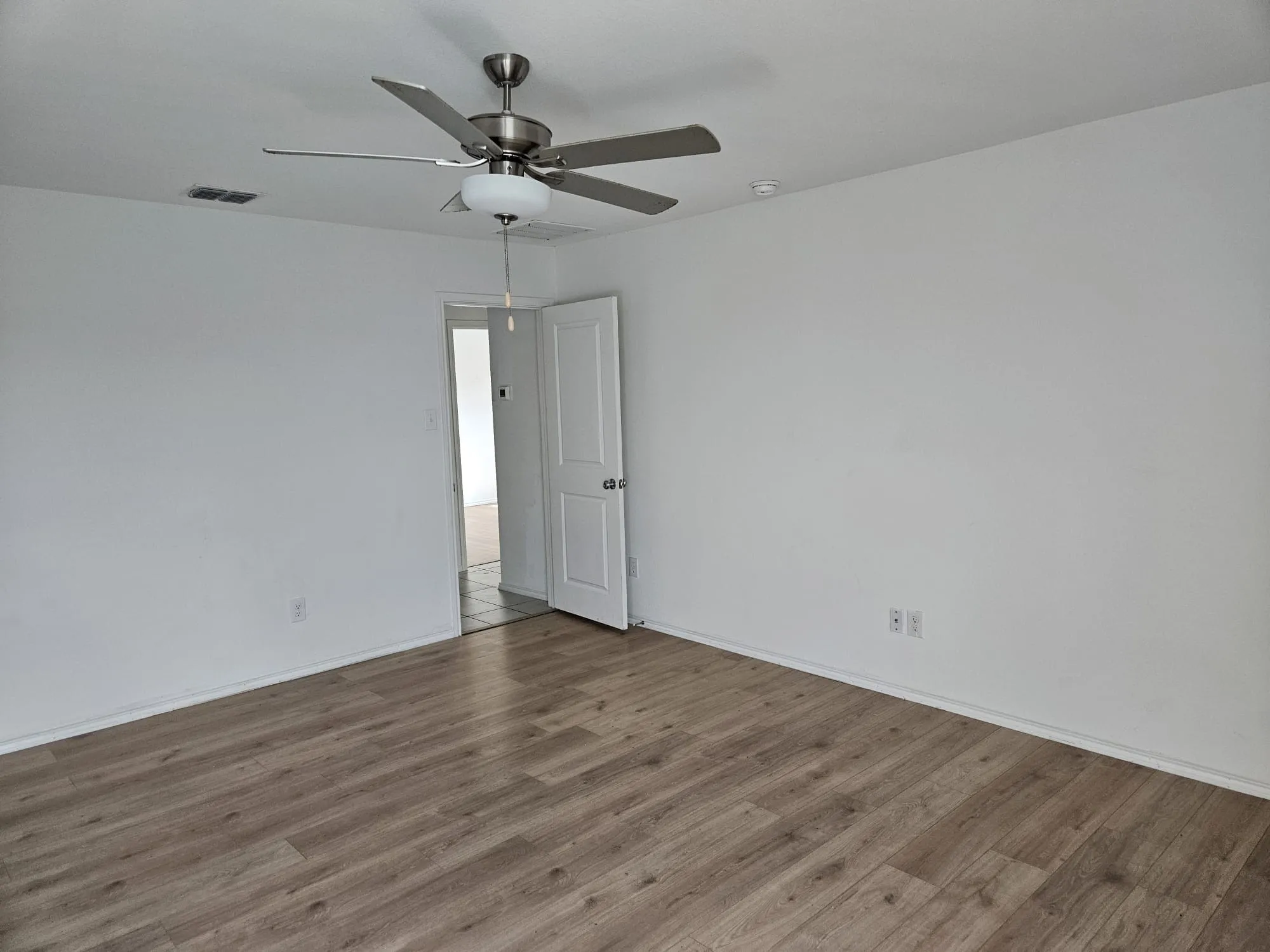 Wood-finish flooring with crisp white walls and ceiling