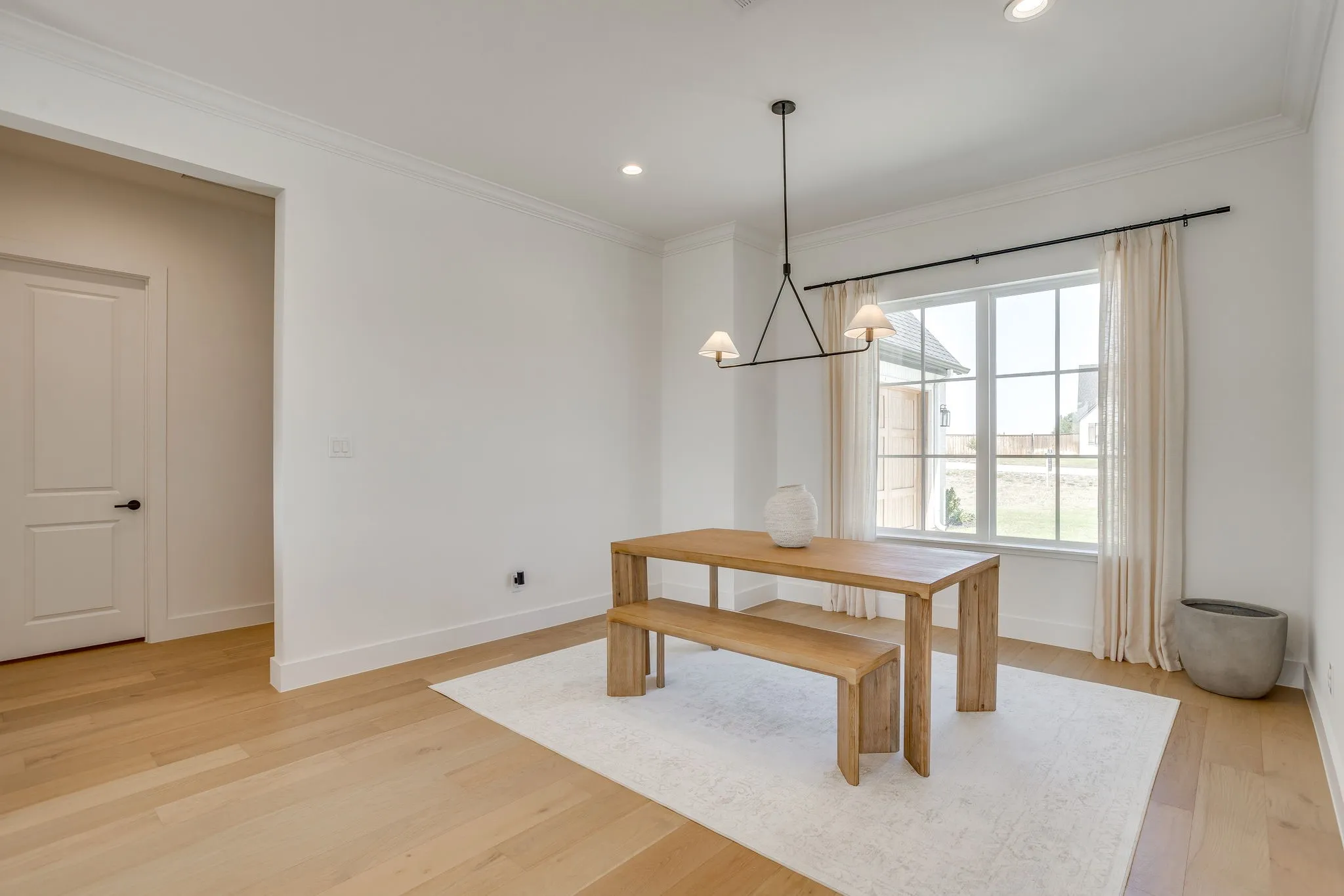 Hardwood flooring, recessed lighting, crown molding, modern chandelier, double-pane window