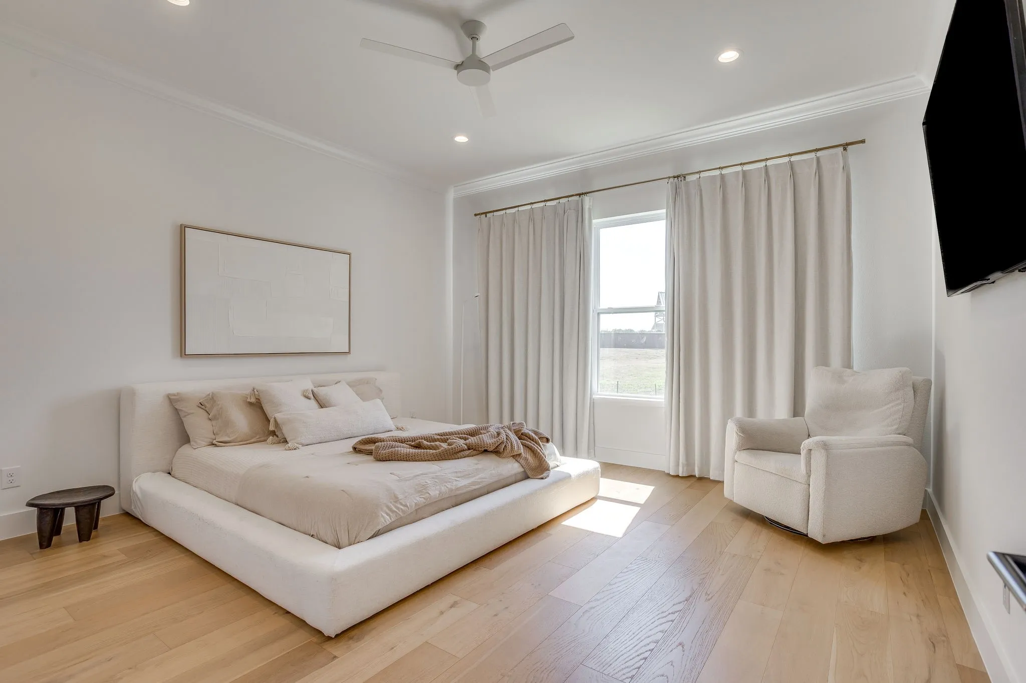 Hardwood flooring, crown molding, recessed lighting, ceiling fan, and large windows with privacy drapes