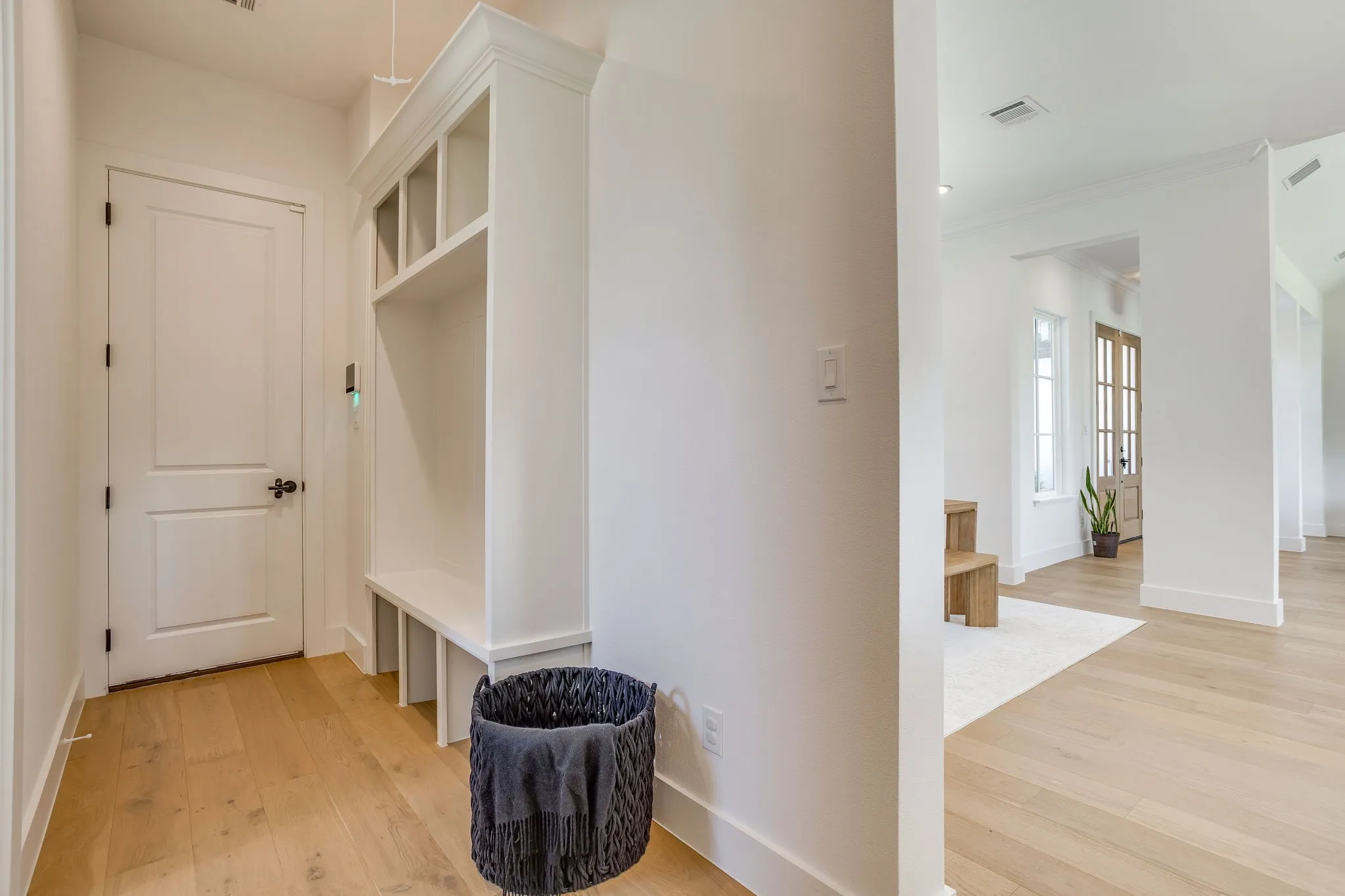 White shaker-style built-in storage bench with upper cubbies
