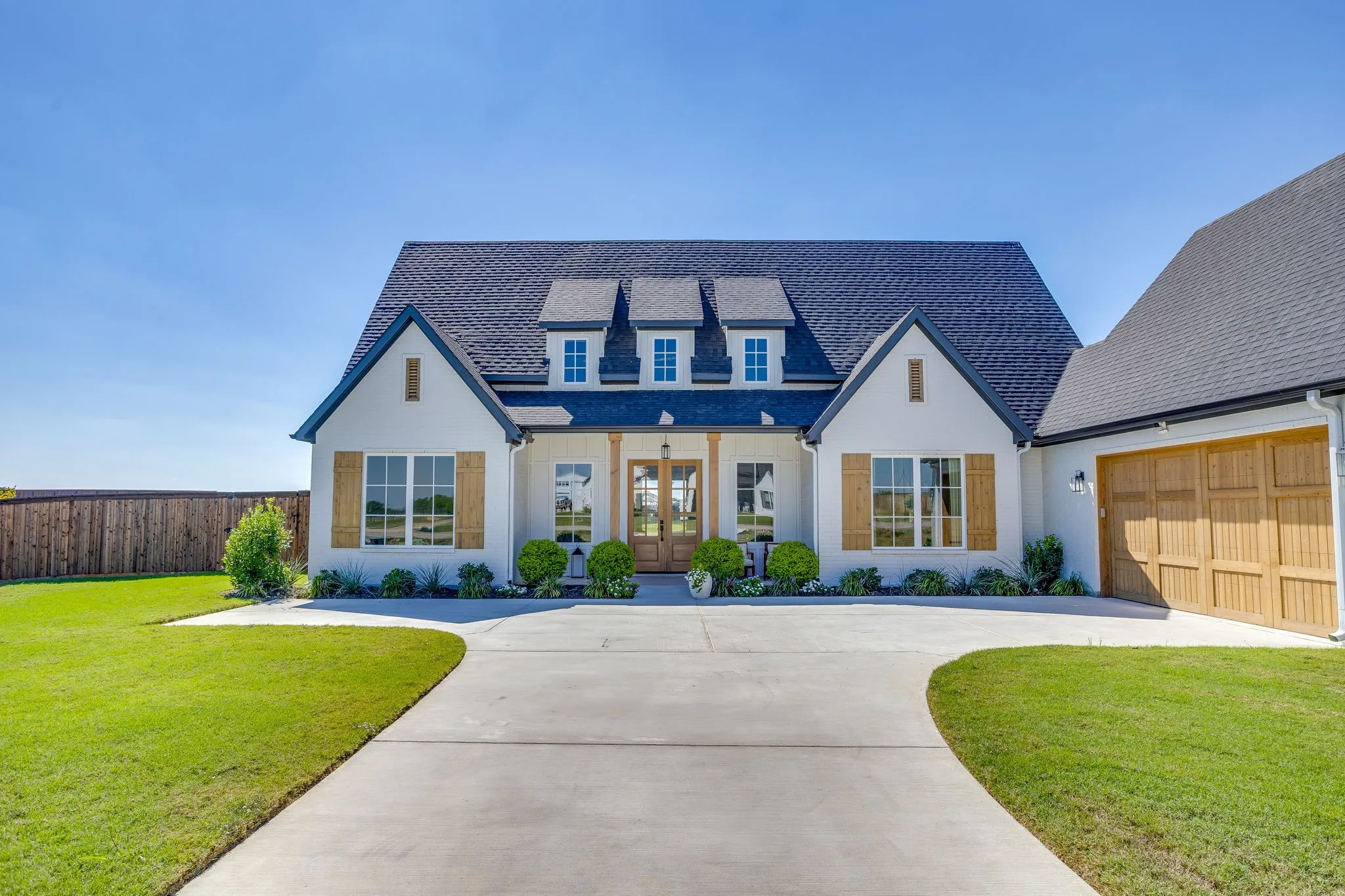 White stucco exterior with dark trim accents