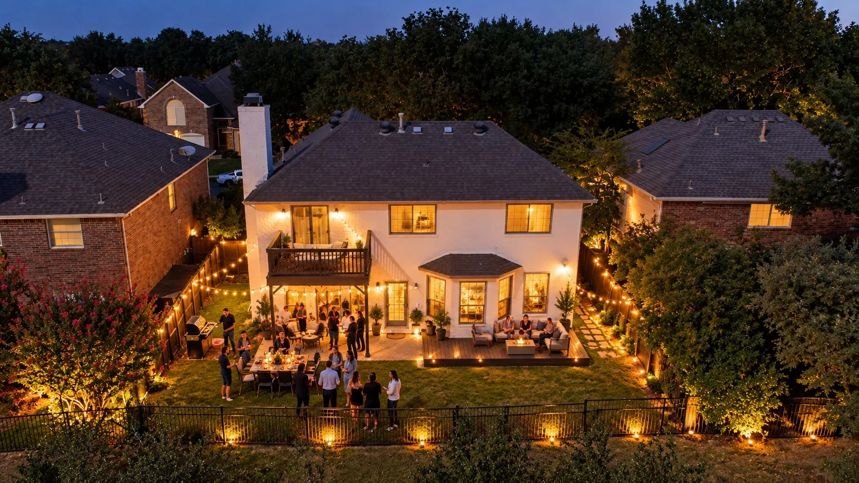 Expansive backyard with a manicured lawn, multi-level deck, and integrated patio spaces