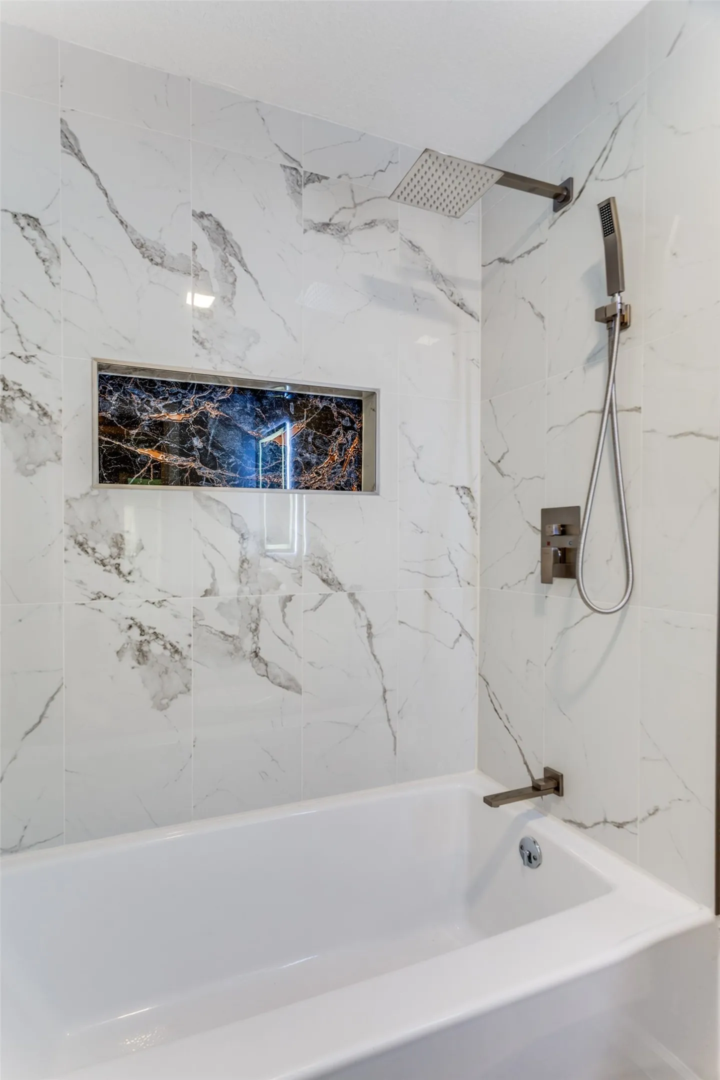 Hall bath close up of tub shower combo tile
