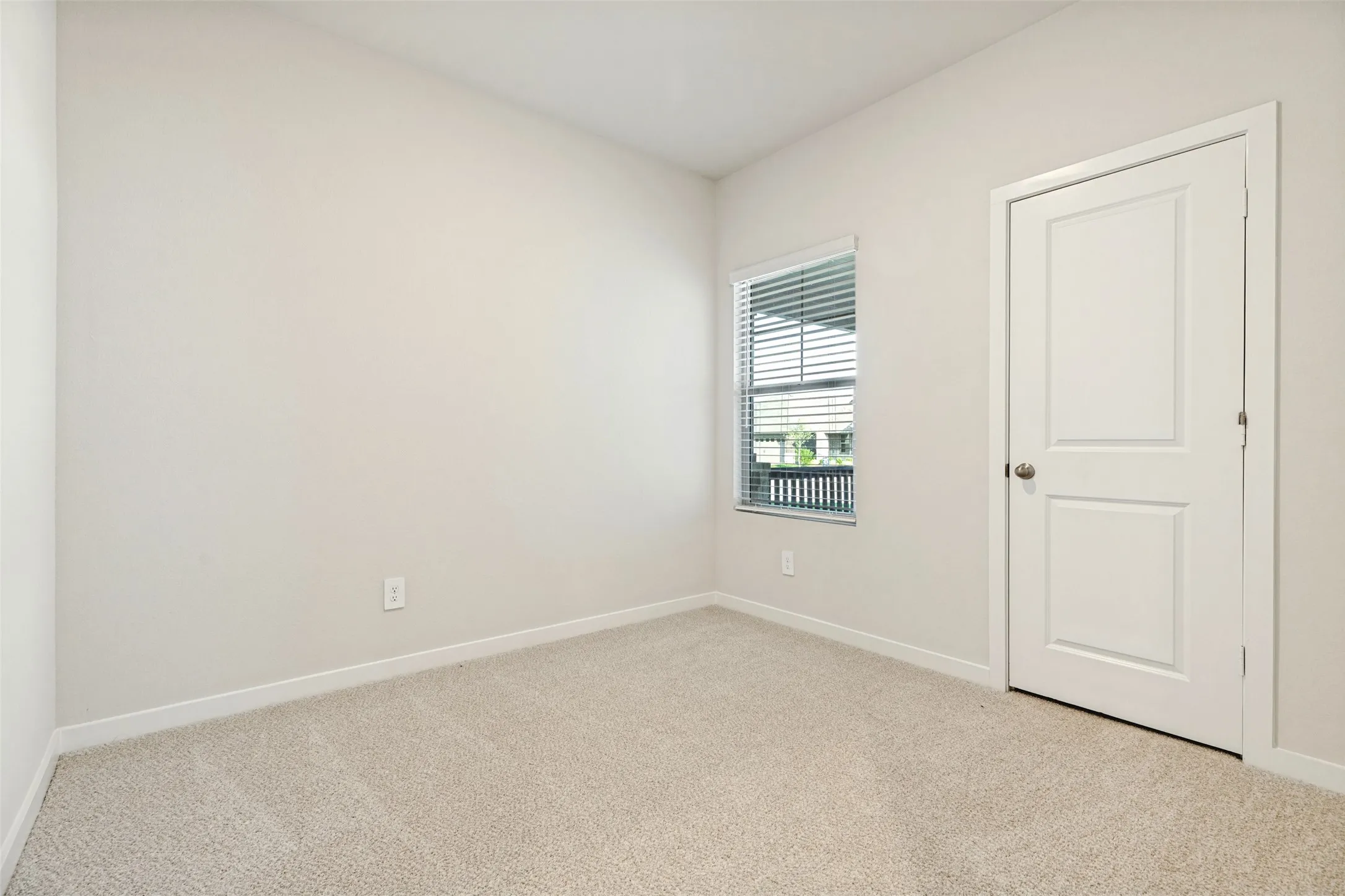 A Flexible Space to Make Your Own! - This bright secondary bedroom features neutral carpeting, crisp white walls, and a window overlooking the covered front porch. An inviting space with possibilities for a guest room, home office, or creative retreat.