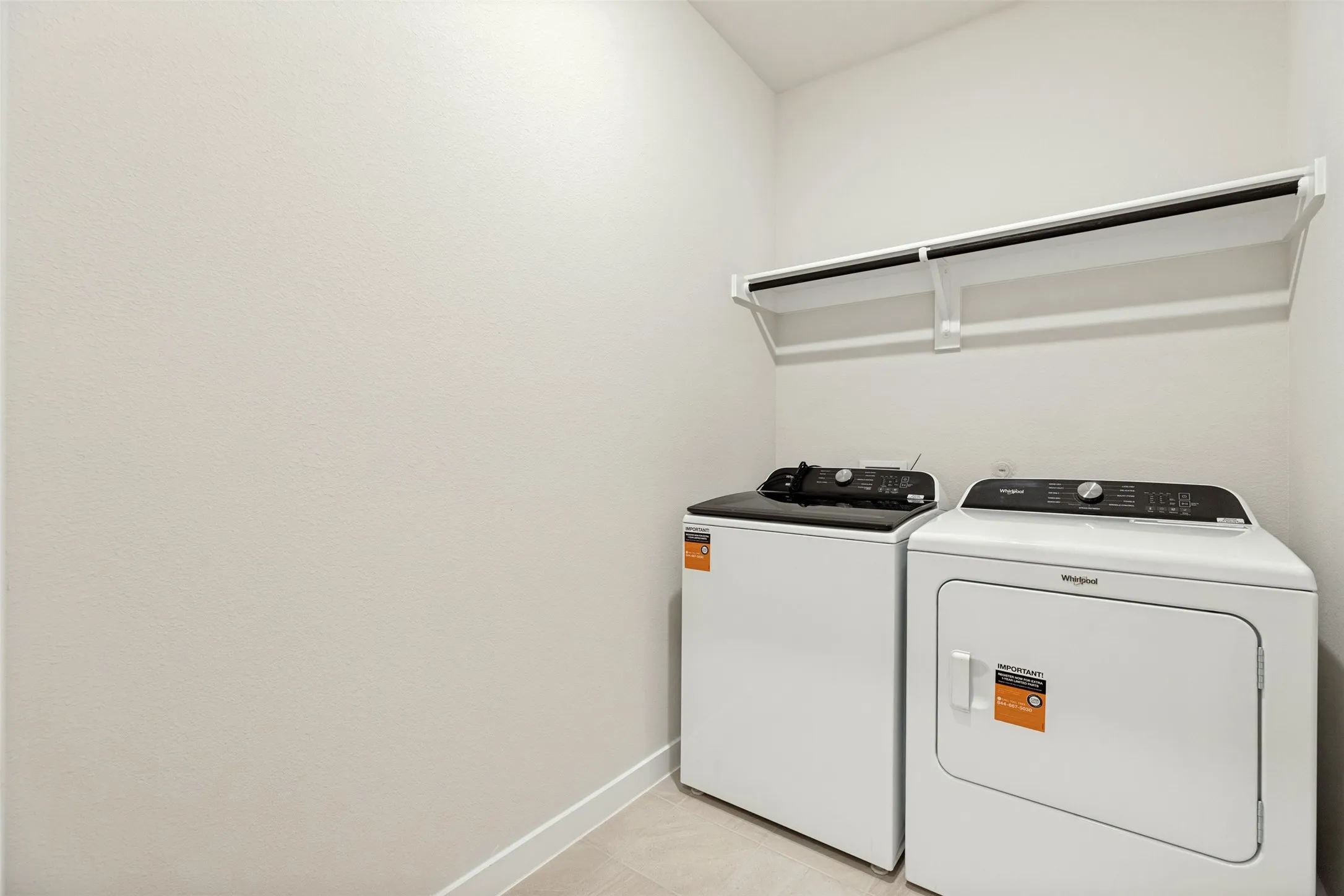 Laundry Made Easy! - The dedicated laundry room comes complete with a Whirlpool washer and dryer, durable tile flooring, and overhead shelving for additional storage. Another move-in-ready convenience that saves you an extra expense!
