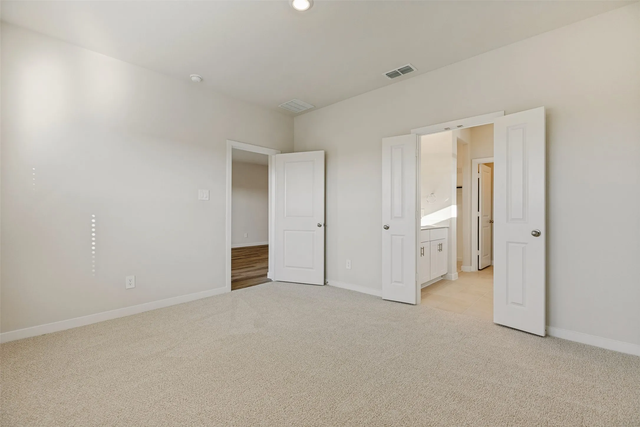 Privacy & Convenience in the Primary Suite! - A thoughtfully designed bedroom layout offers plenty of space to unwind, with direct access to the private ensuite bathroom featuring a double-sink vanity, separate shower, and walk-in closet.