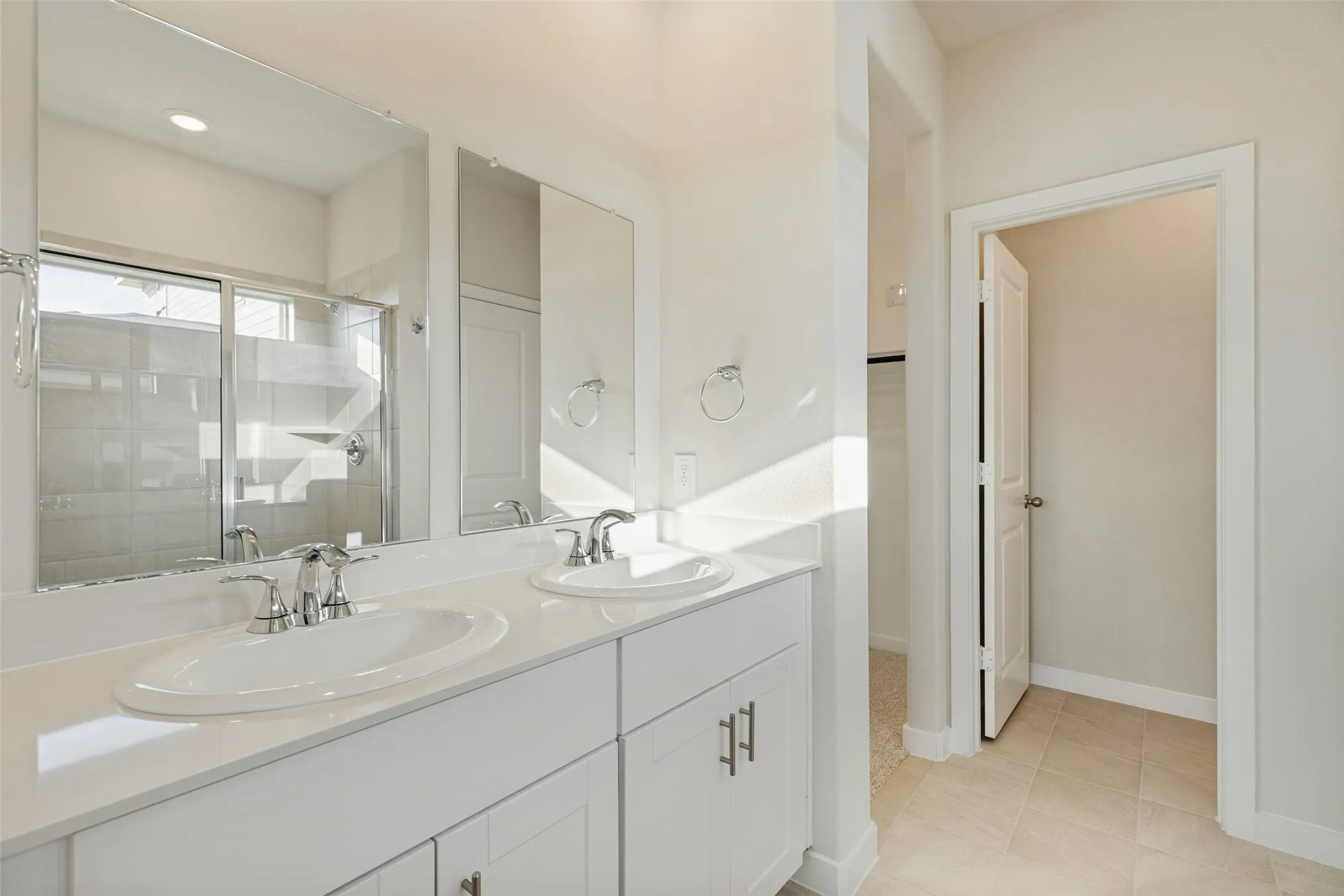 Double the Convenience! - Two separate sinks, generous vanity counter space, individual mirrors, and convenient cabinet storage make morning and evening routines easier in this bright, beautifully finished primary bathroom.