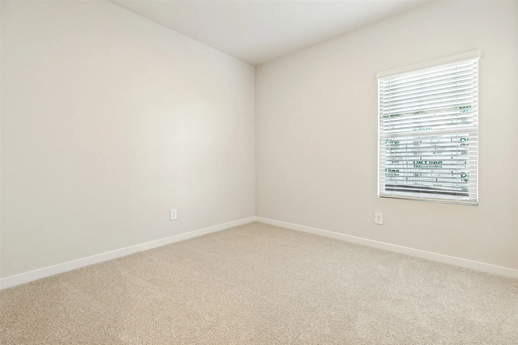 Comfortable, Bright & Move-In Ready! - This secondary bedroom offers soft carpeting, fresh neutral finishes, and natural light through a window with included blinds. A clean, versatile space ready to accommodate your personal style.