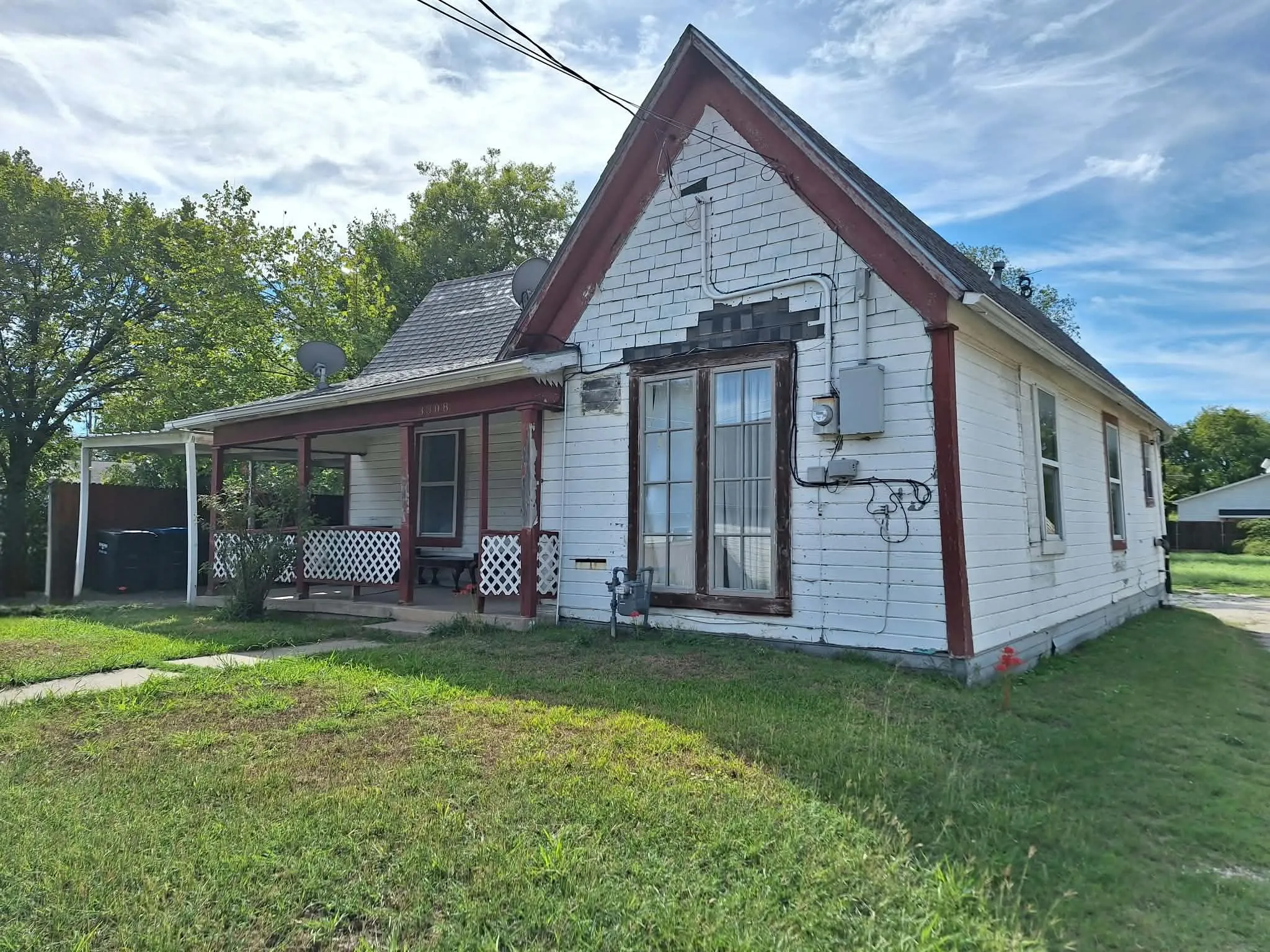 Covered front porch with white lattice railing