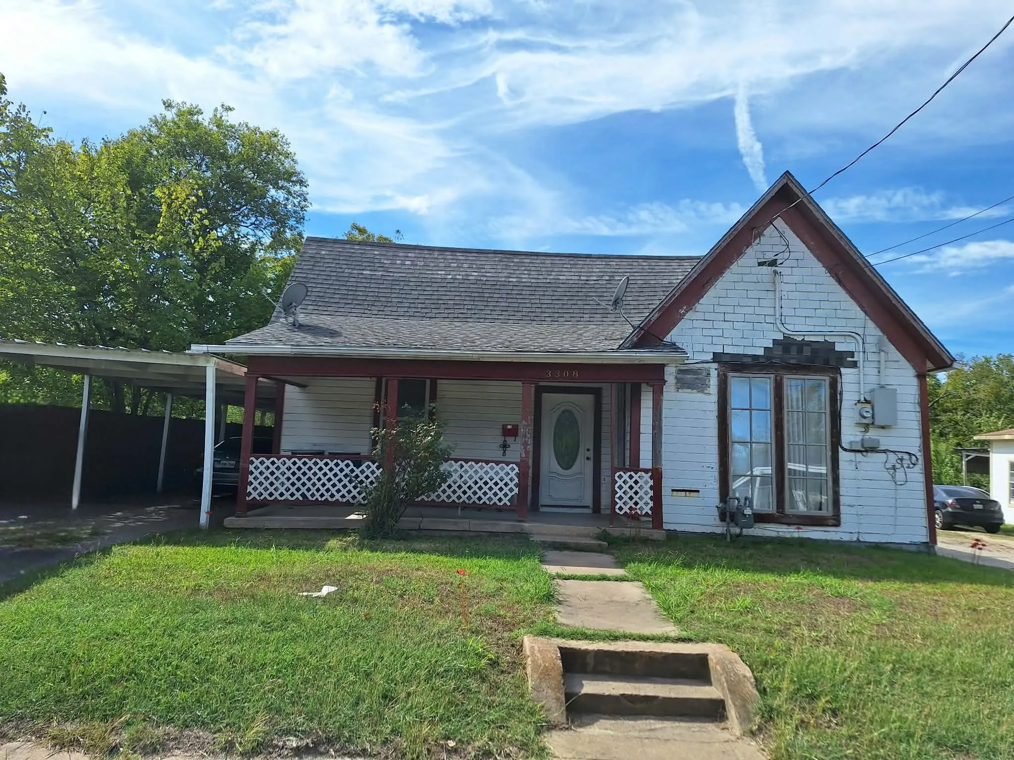 Front exterior featuring a covered porch, white siding, and a gabled roofline