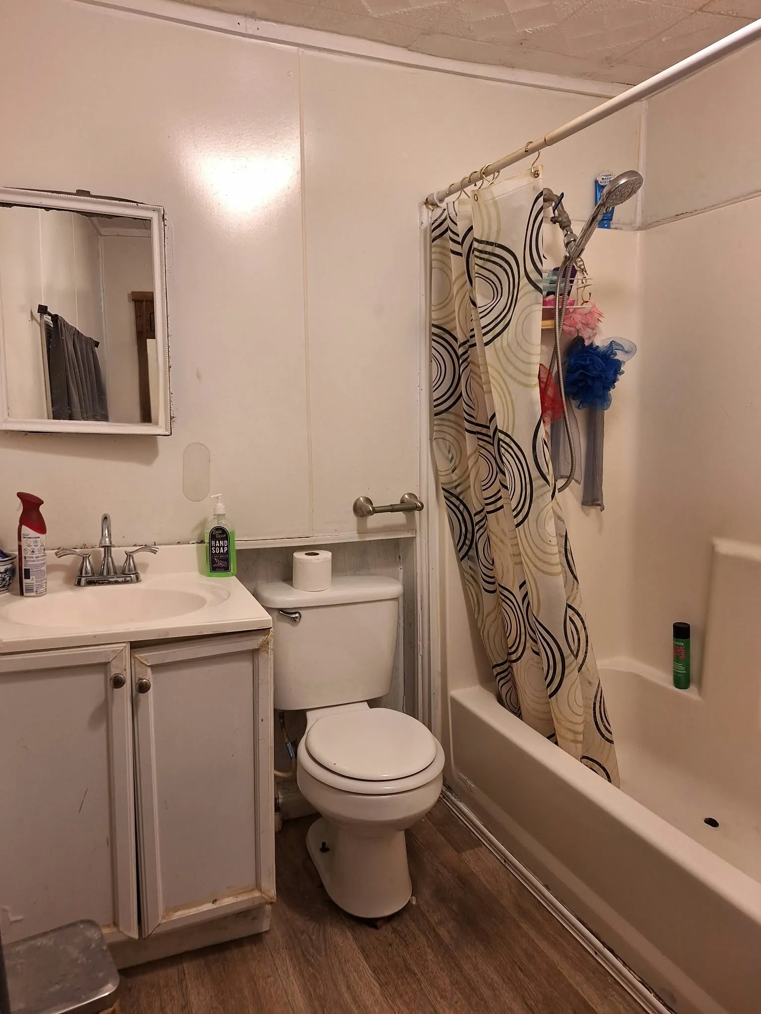 Bathroom featuring a built-in vanity with sink, toilet, and a shower-tub combination