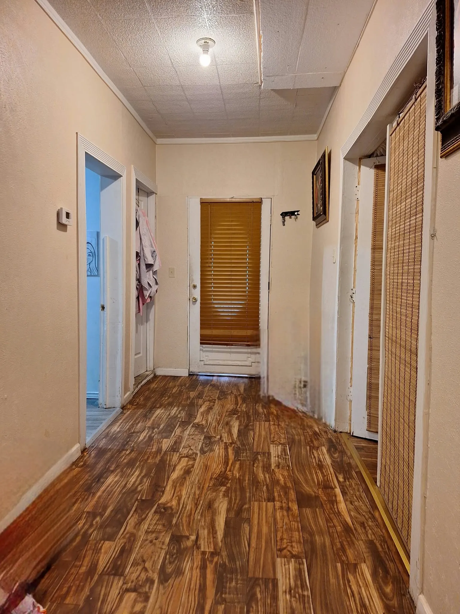 Wood-finish flooring throughout, featuring a neutral color palette and white trim
