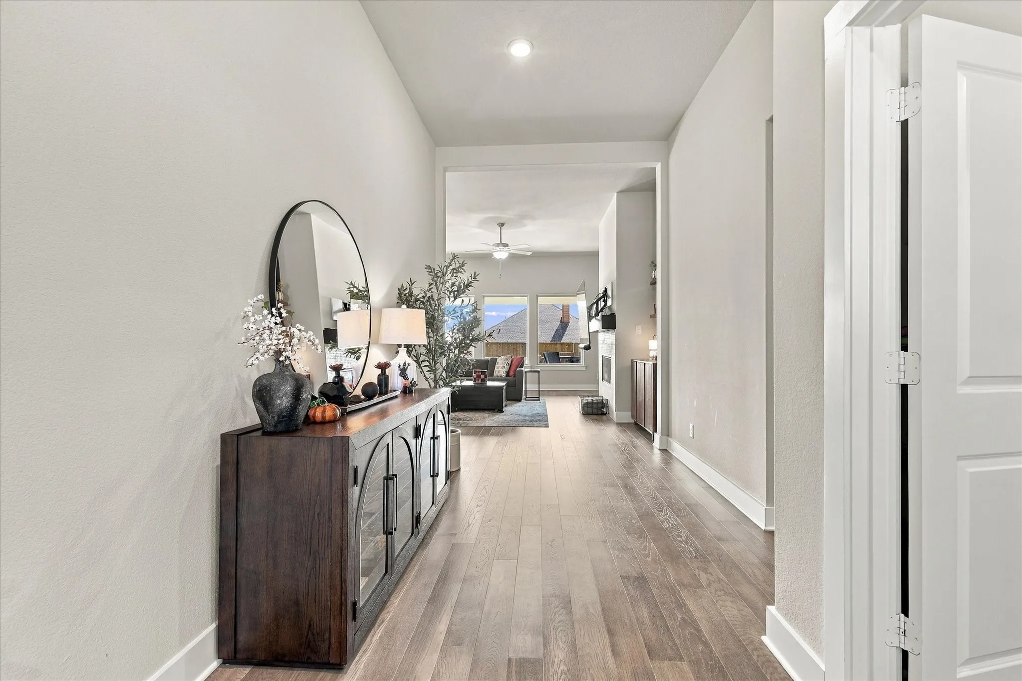 View on Entry with luxury vinyl plank flooring and high ceilings. Office is to the right.