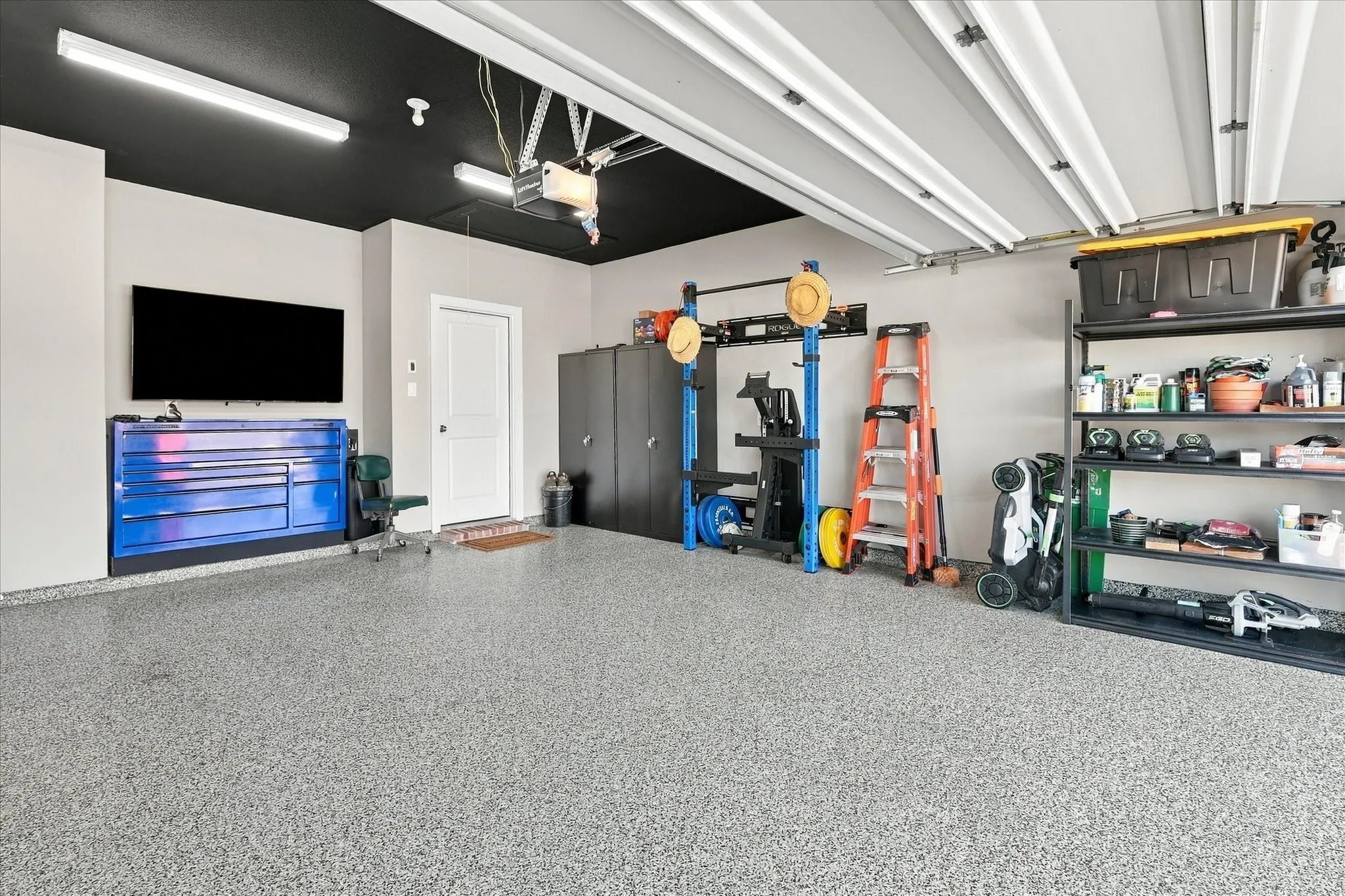Epoxy painted floor, extra lighting above and a car washing spigot in the garage.