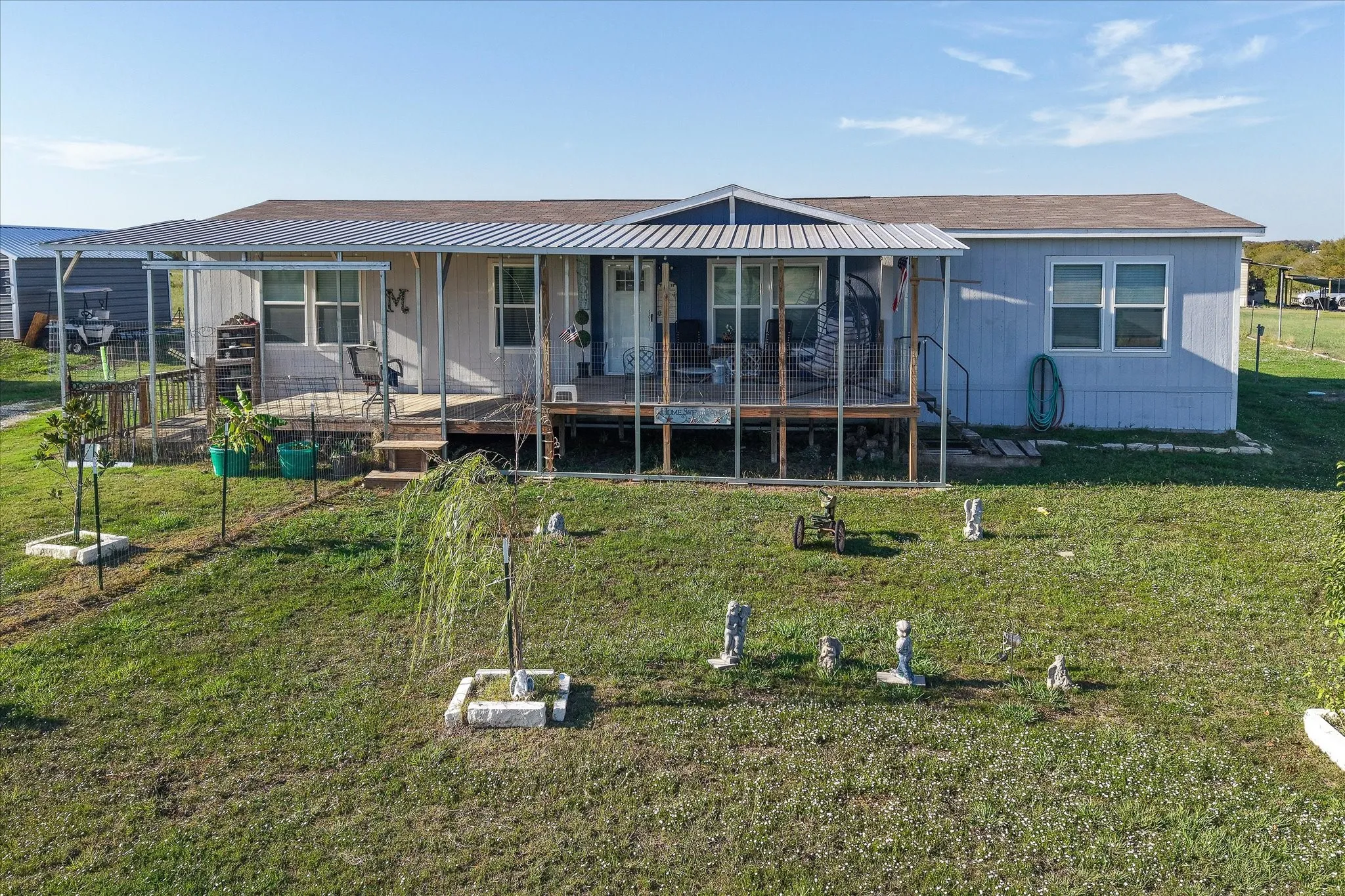 Front yard with large deck and patio.