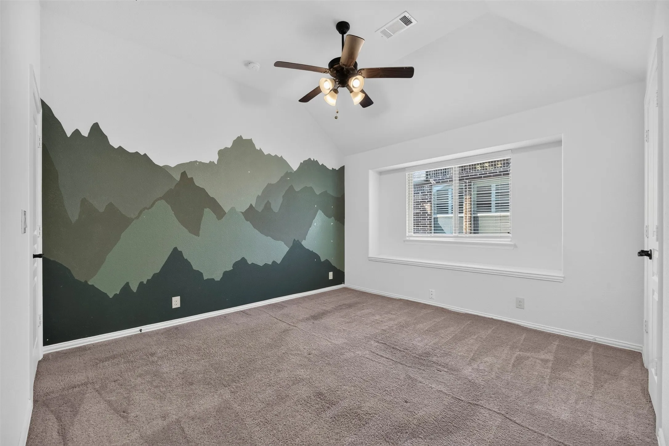 Vaulted ceiling with a ceiling fan, carpeted flooring, and a window with blinds