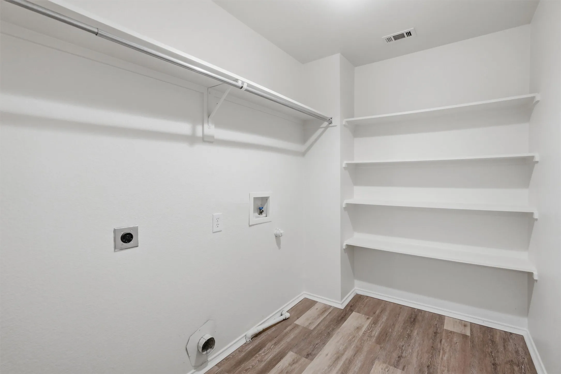 Built-in shelving, hanging rod, and wood-finish flooring