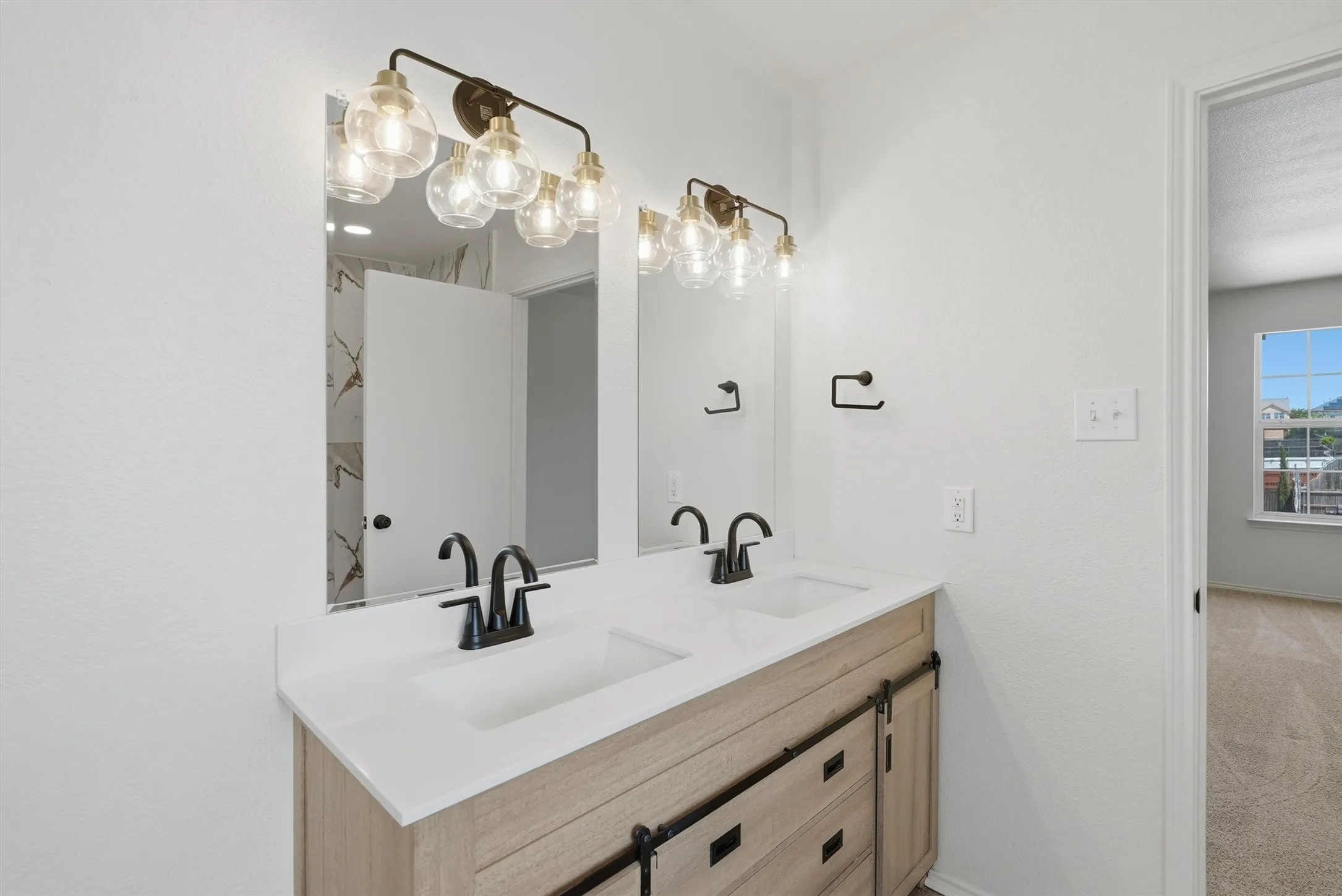 Dual vanity with integrated sinks, white countertop, and matte black fixtures