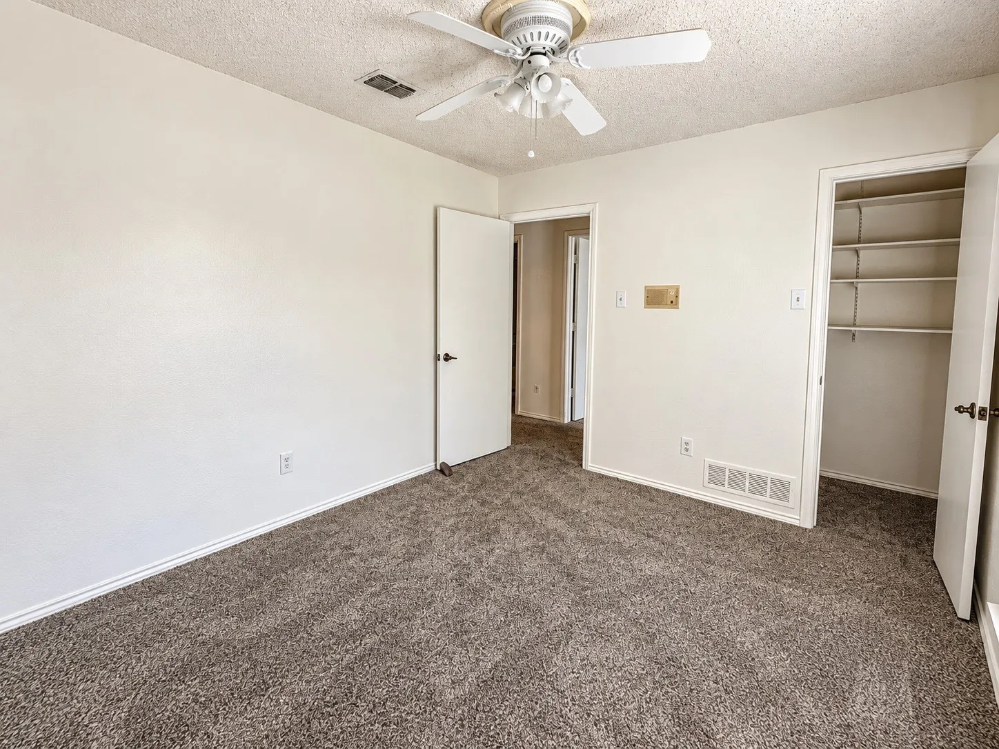 Wall-to-wall carpeting and white walls