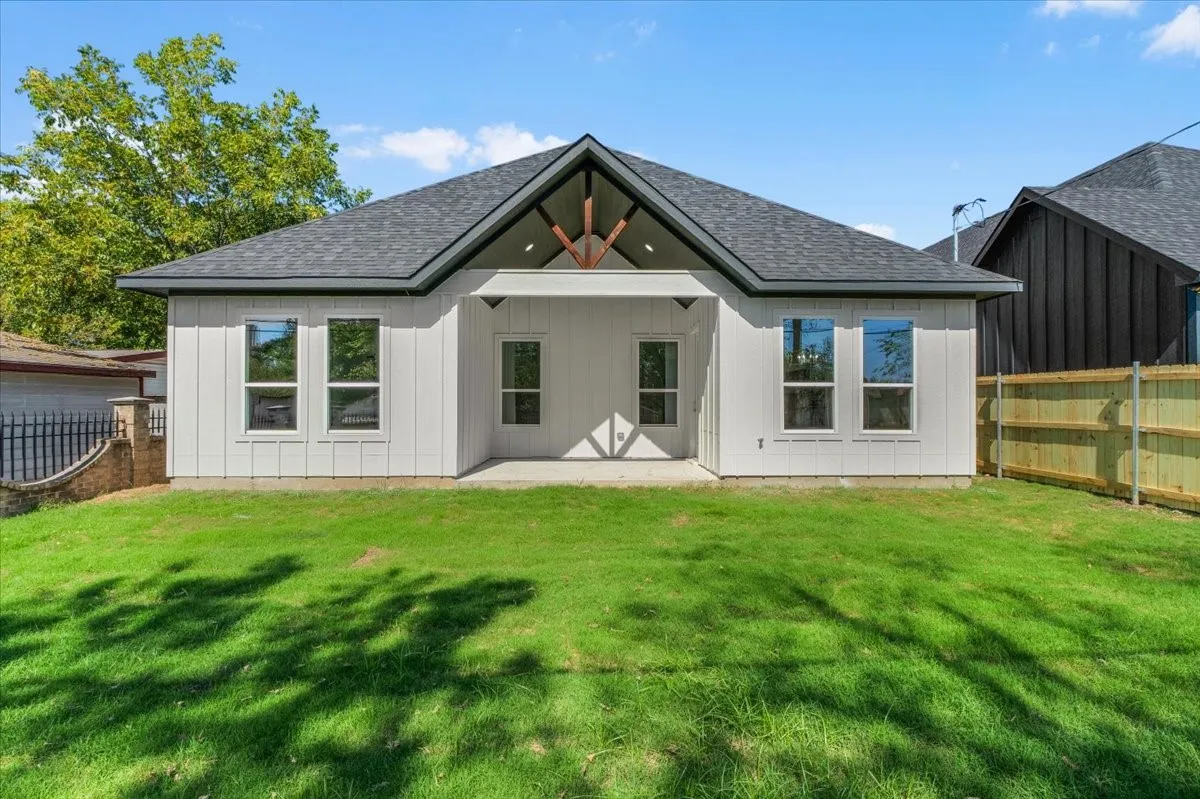 Modern white siding exterior with a dark shingle roof
