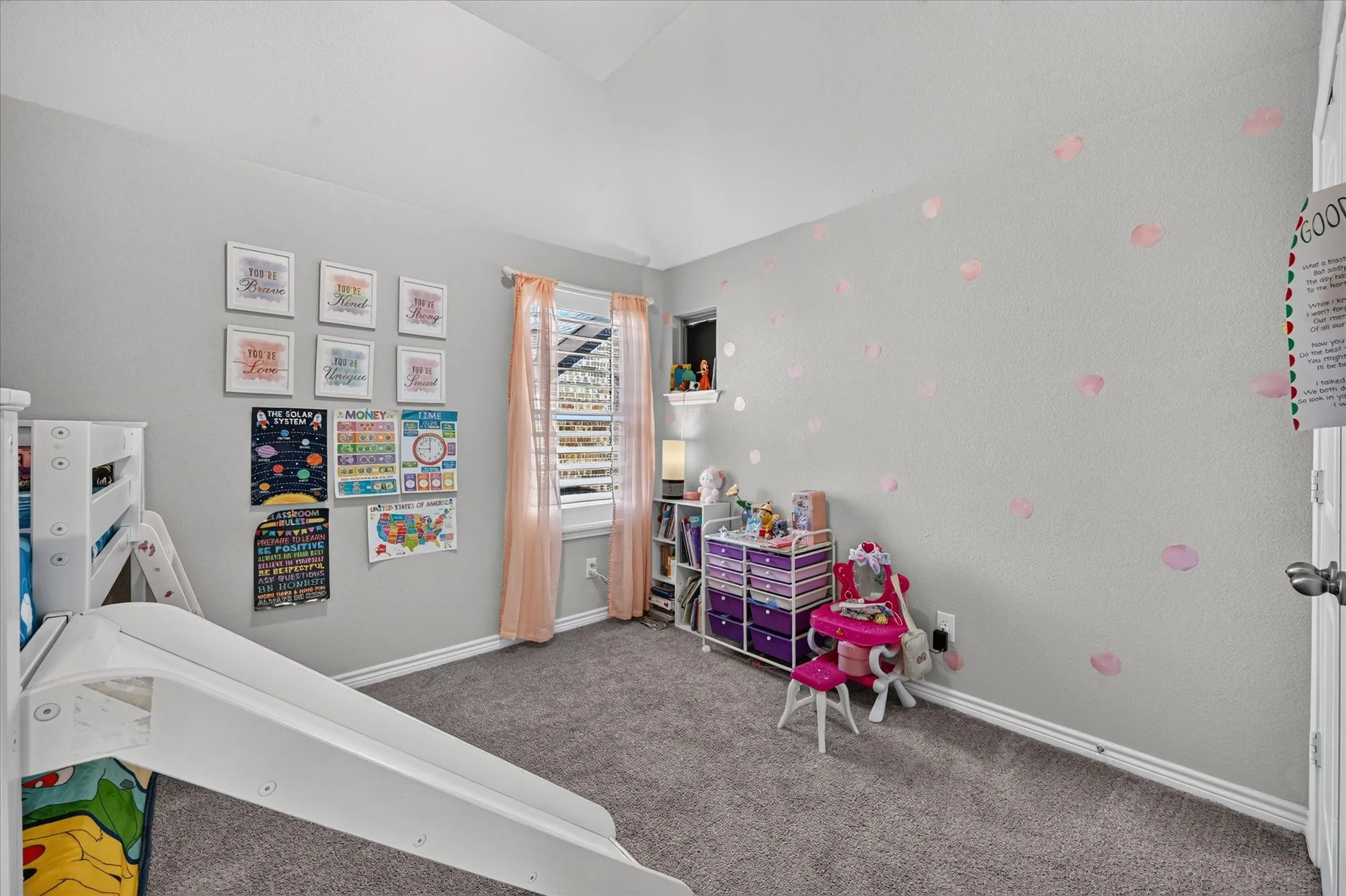 Carpeted flooring, vaulted ceiling, and window with blinds