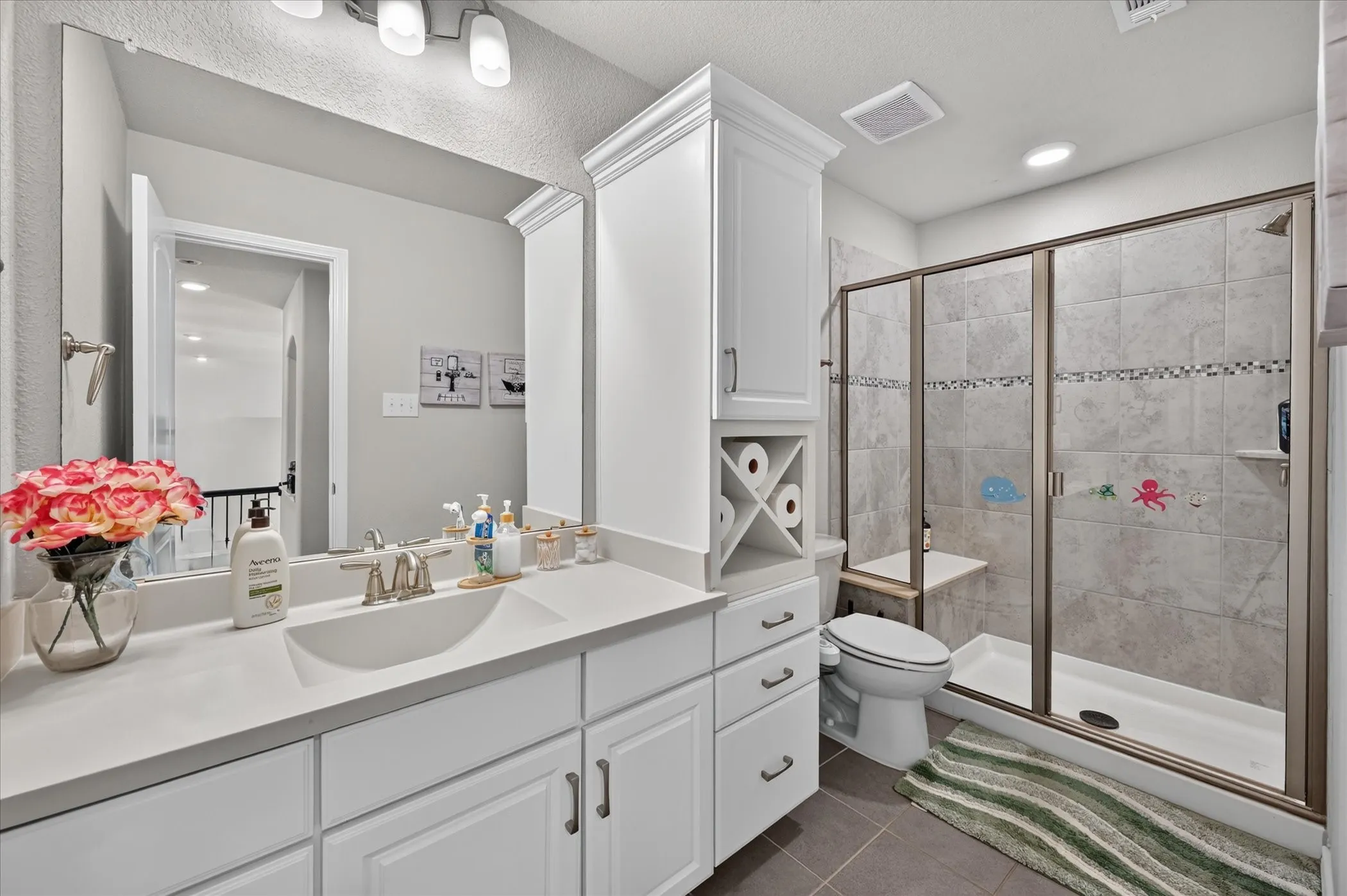 Dual vanity with integrated sinks, white cabinetry, and brushed nickel fixtures