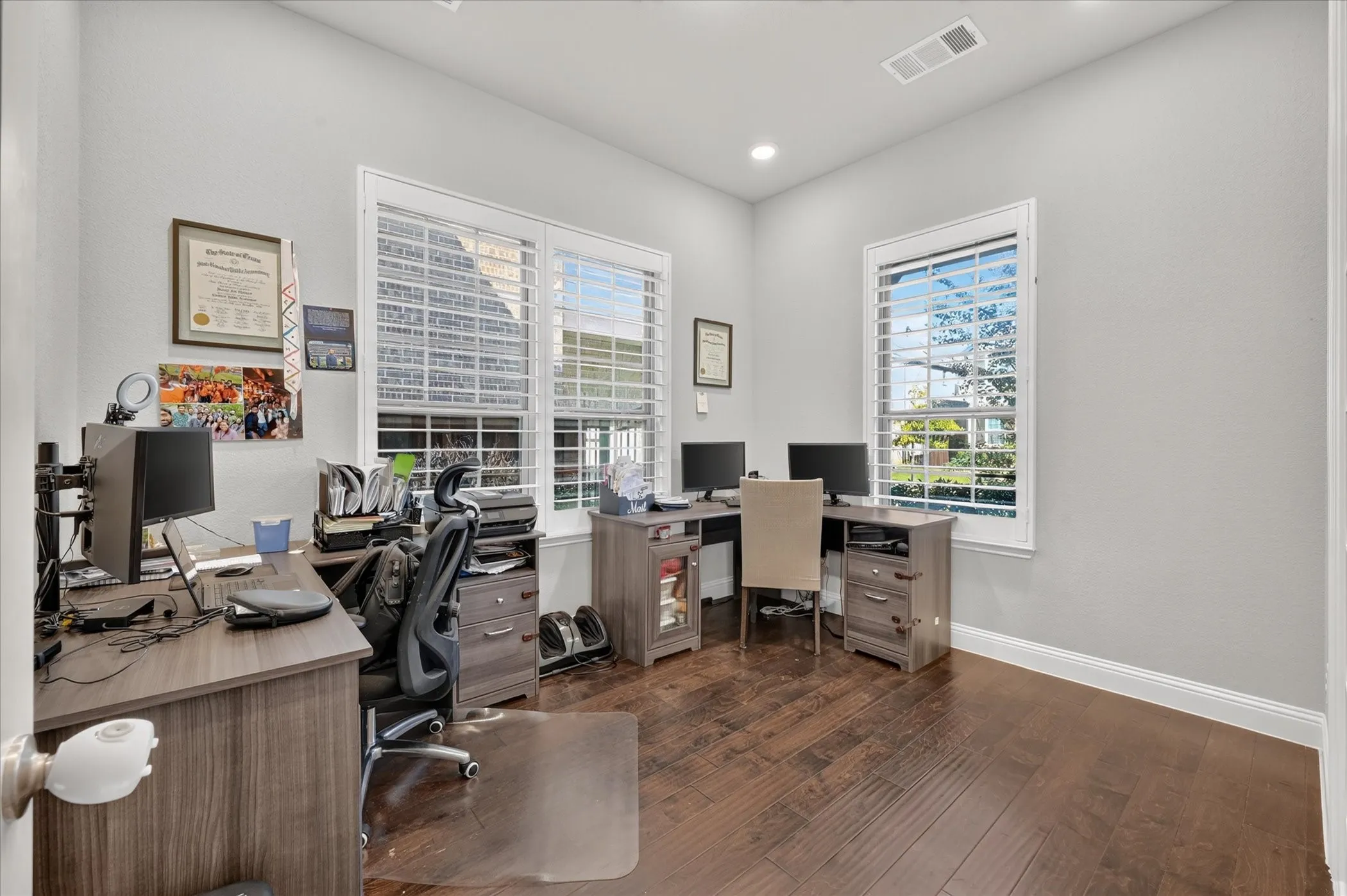 Recessed lighting, wood-finish flooring, and white trim