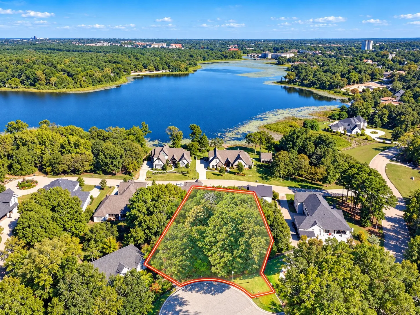 Cleared lot with mature trees, situated on a cul-de-sac, offering close proximity to a large body of water