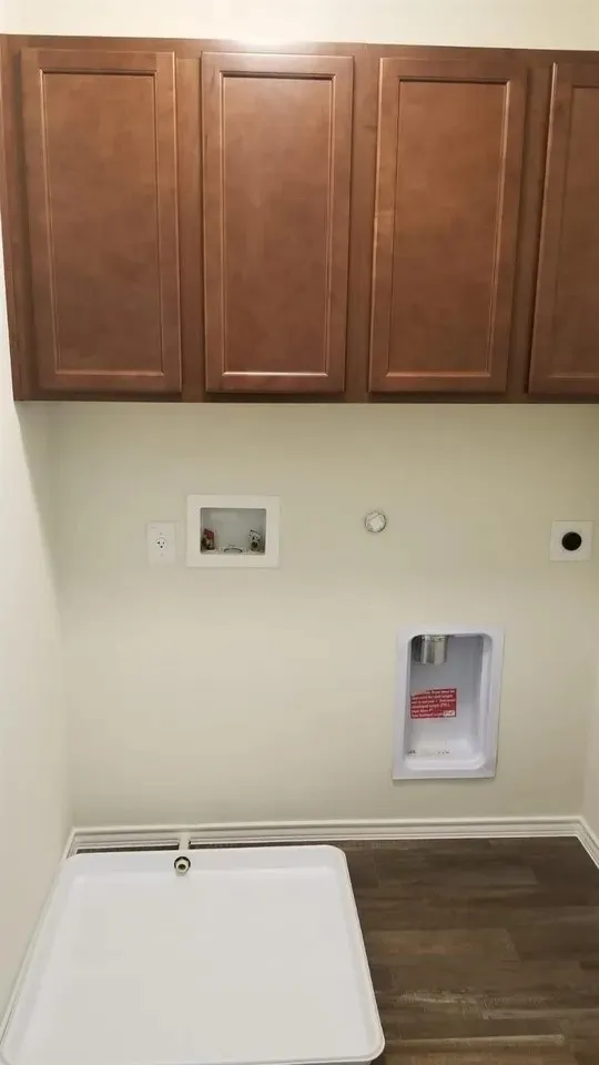 Wood-finish flooring with a white drip pan