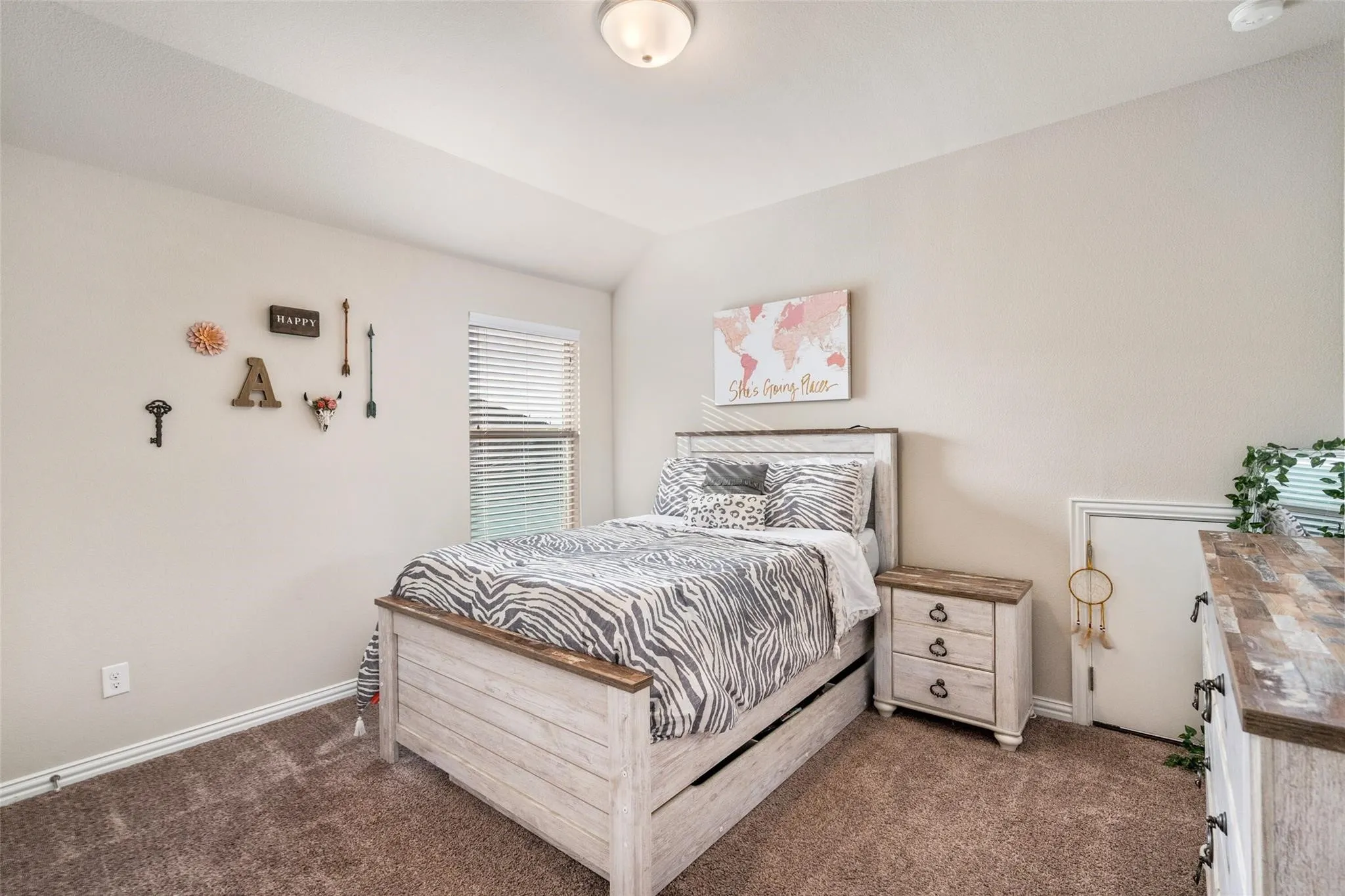 Neutral-toned walls complement the textured carpet flooring