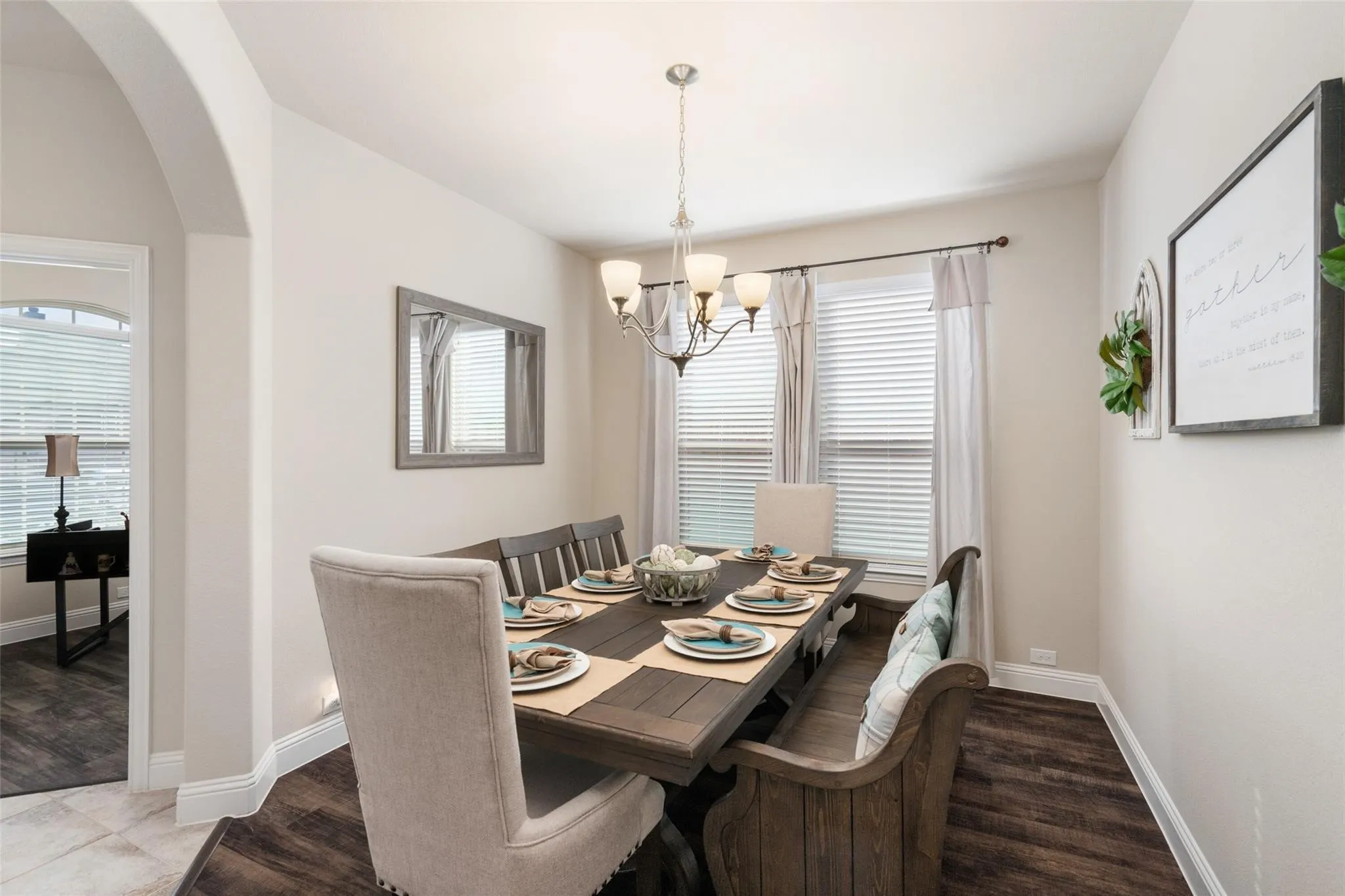 Recessed lighting accents a spacious dining area with wood-finish flooring