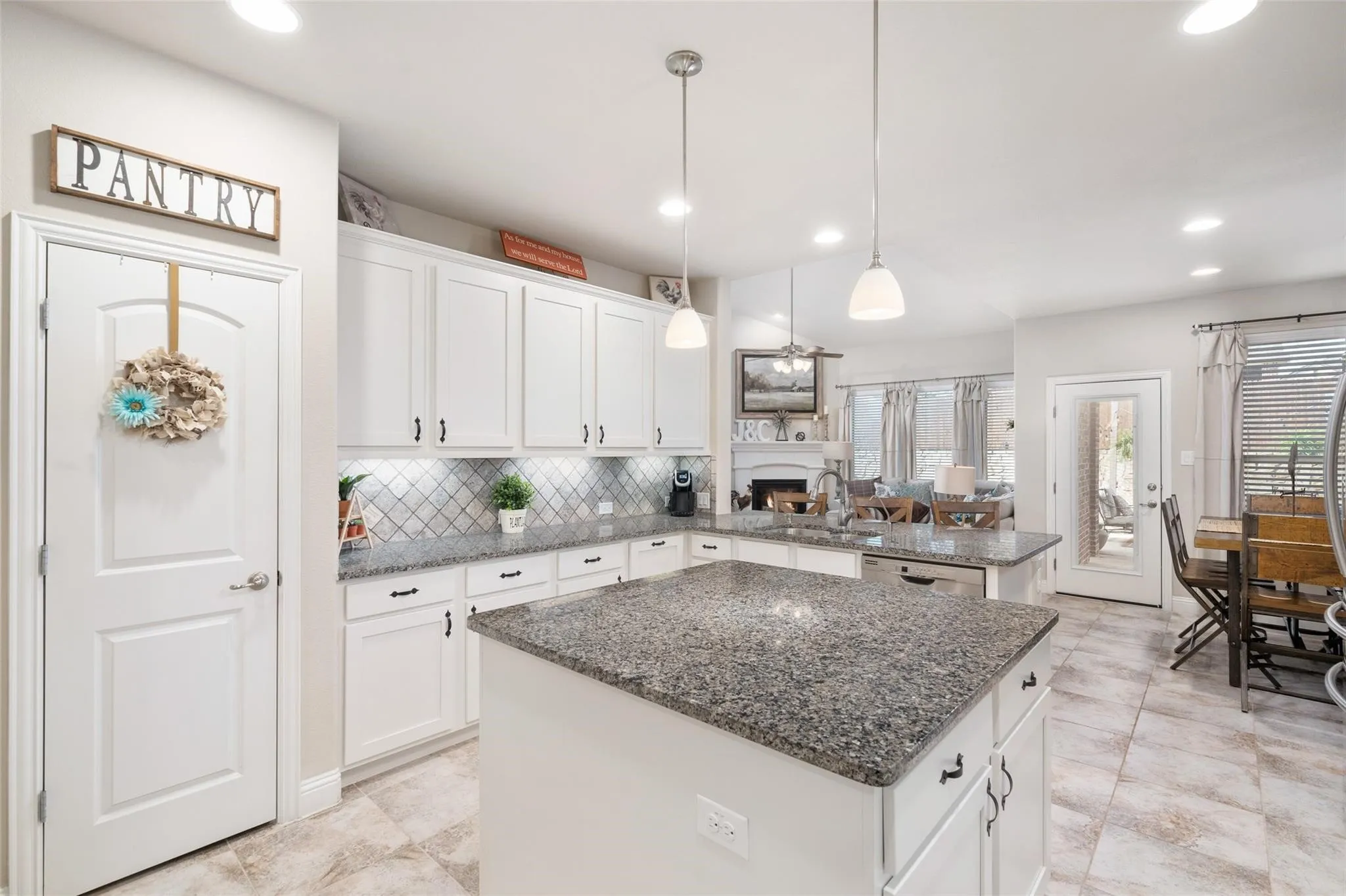 Kitchen featuring white shaker cabinetry, granite countertops, a tiled backsplash, and recessed lighting