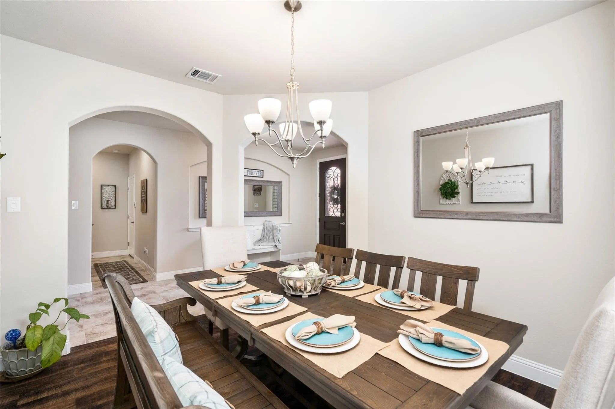 Recessed lighting, arched doorways, wood-finish flooring, tile flooring, and a chandelier