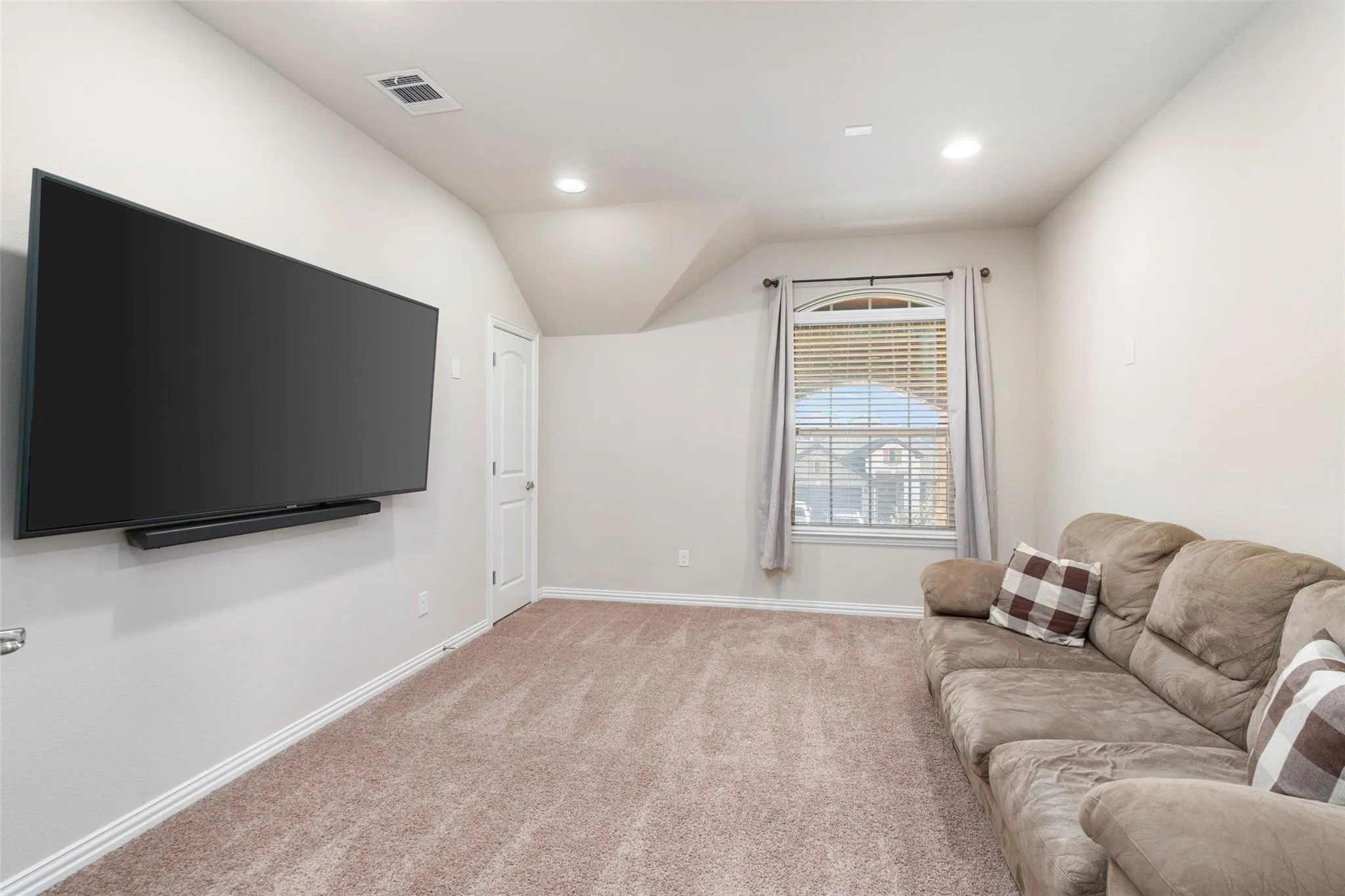 Neutral-toned walls complement the carpeted flooring