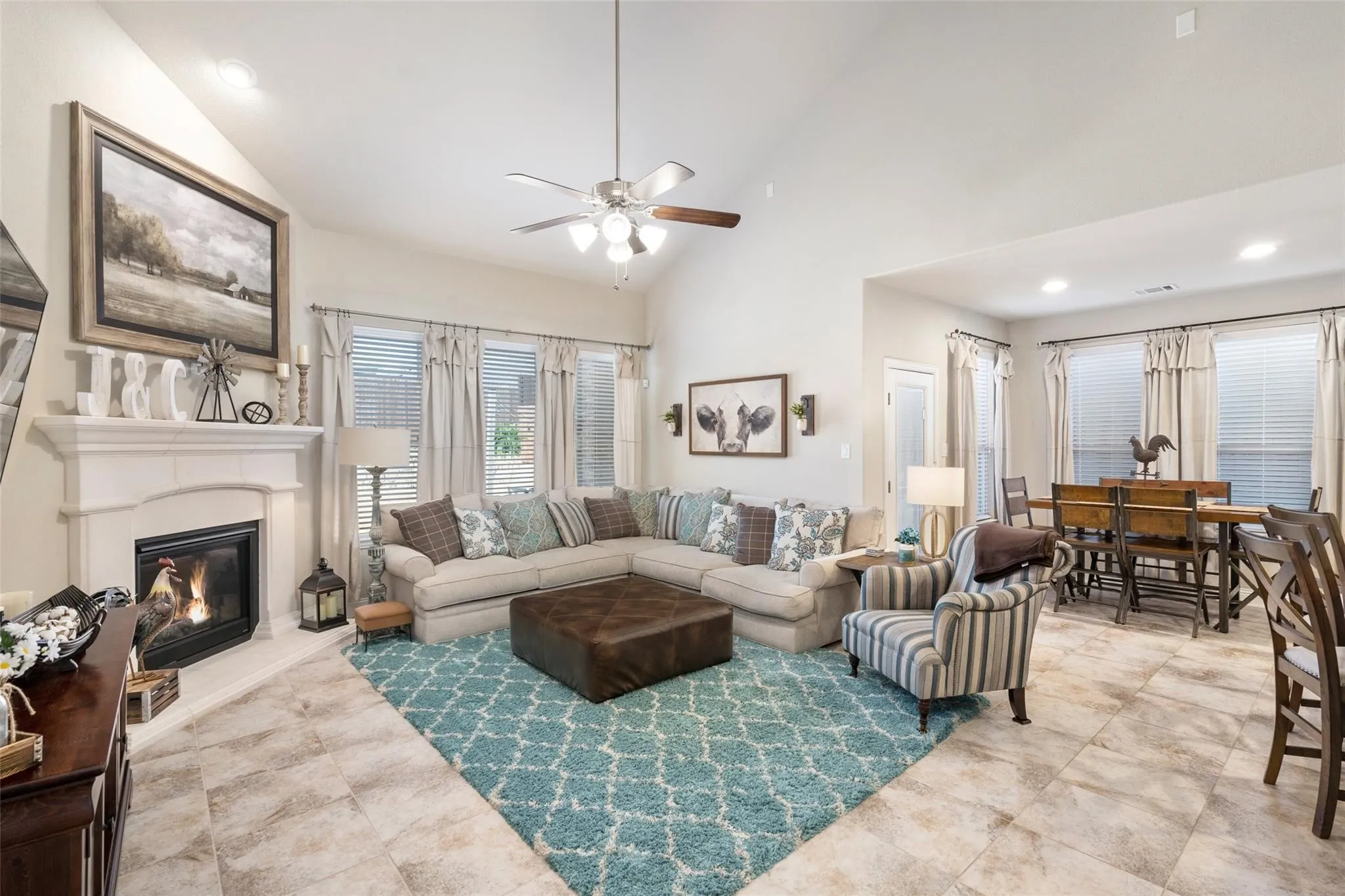 Vaulted ceiling with a ceiling fan, recessed lighting, and tile flooring