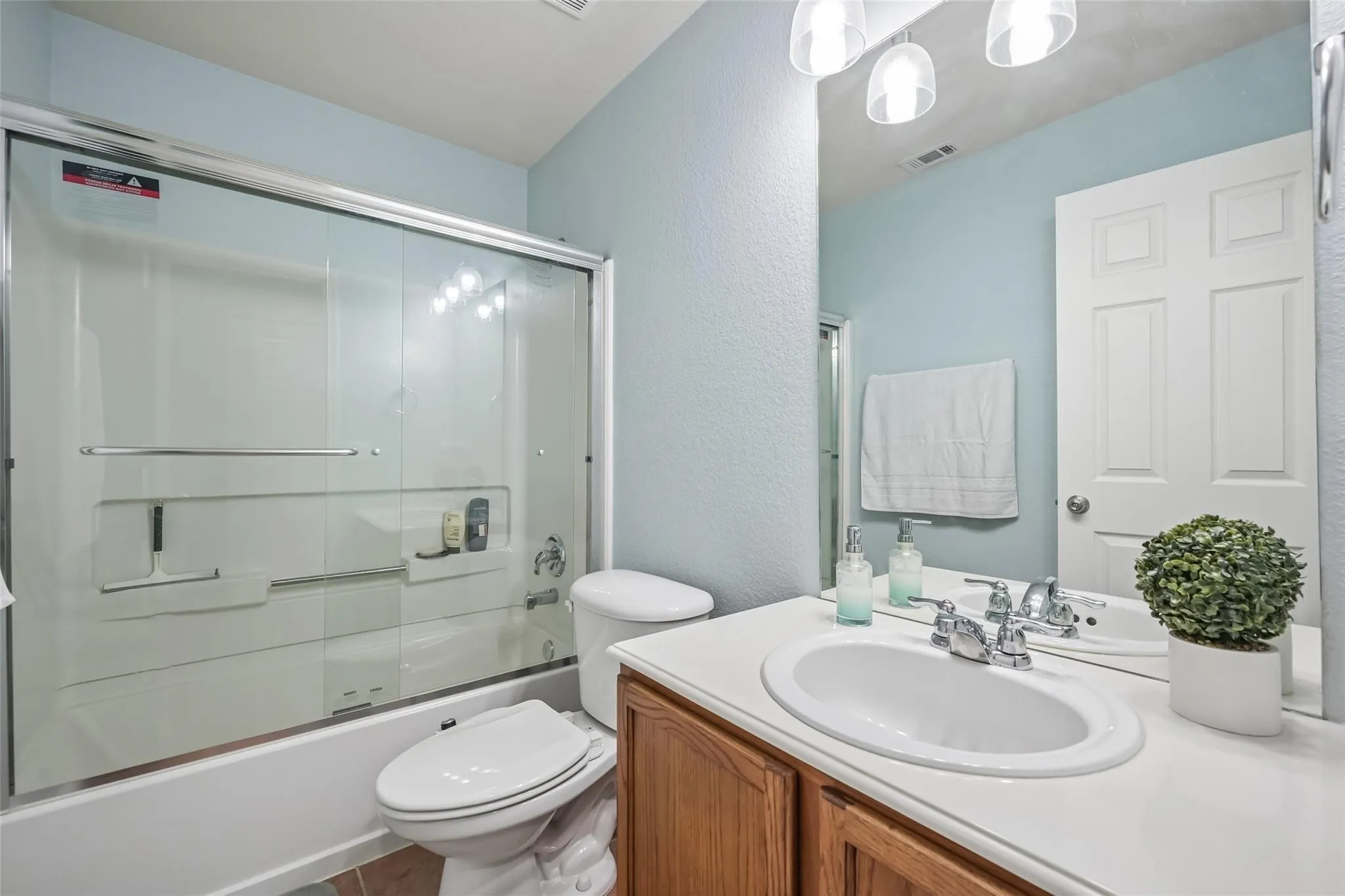 White countertop vanity with an undermount sink and chrome faucet