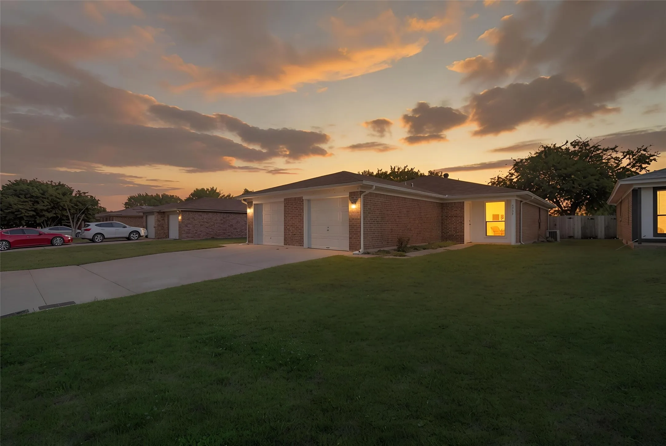 Brick exterior with a gabled roof and attached two-car garage