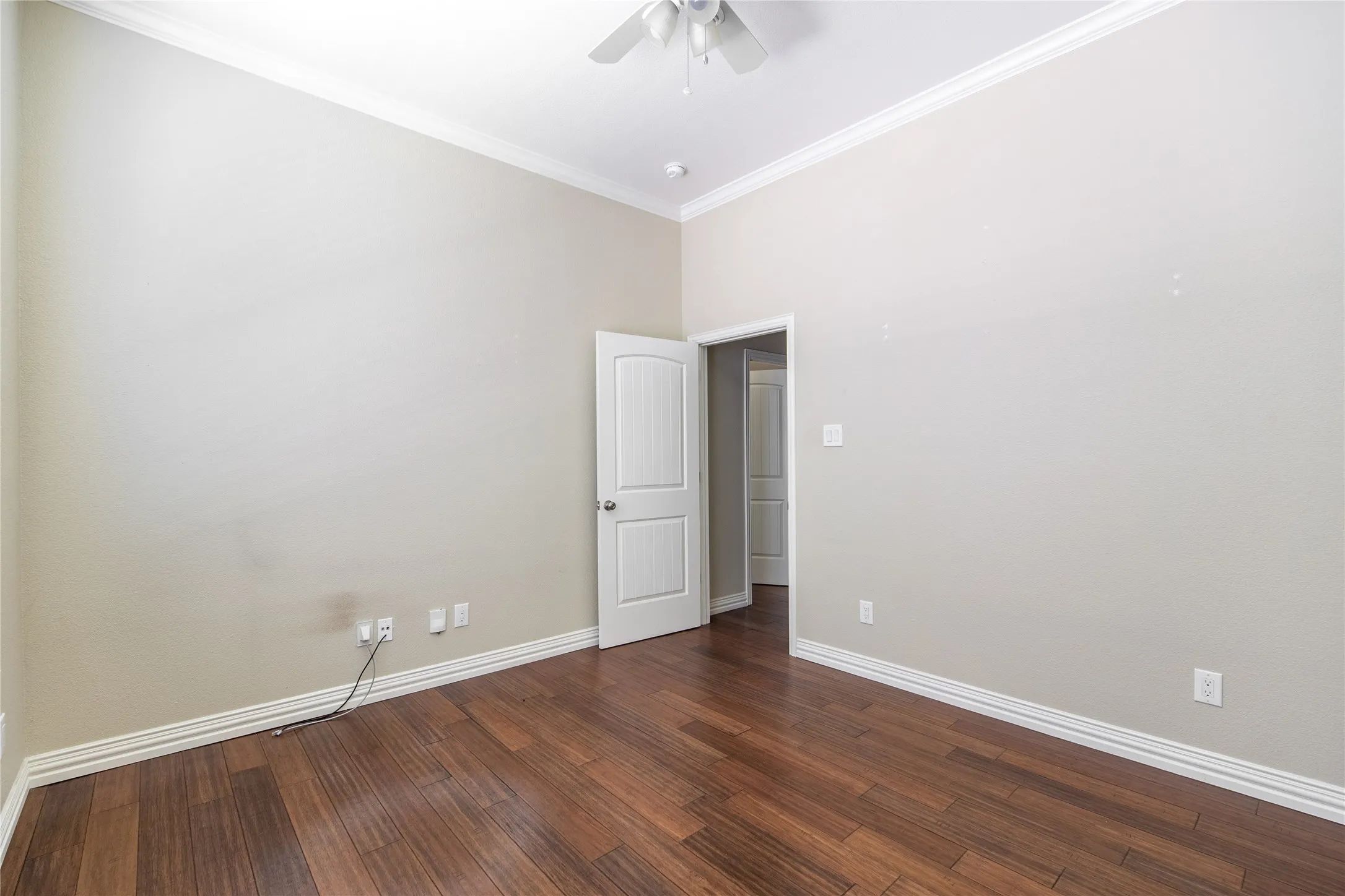 Wood-finish flooring, vaulted ceiling, and crown molding