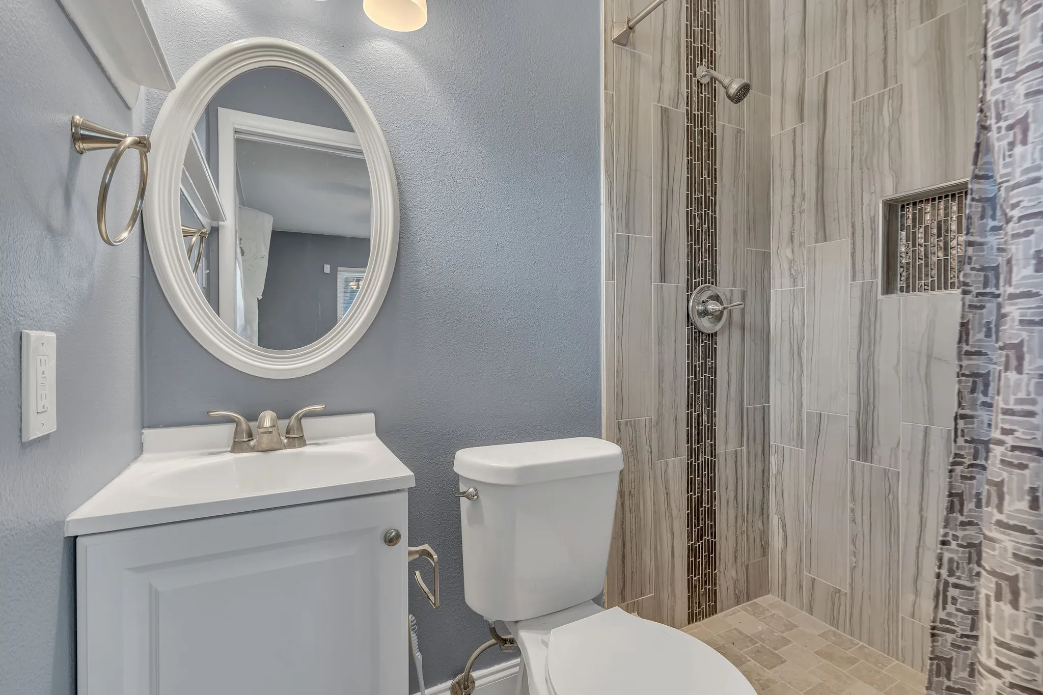 Corner vanity with an integrated sink and brushed nickel faucet