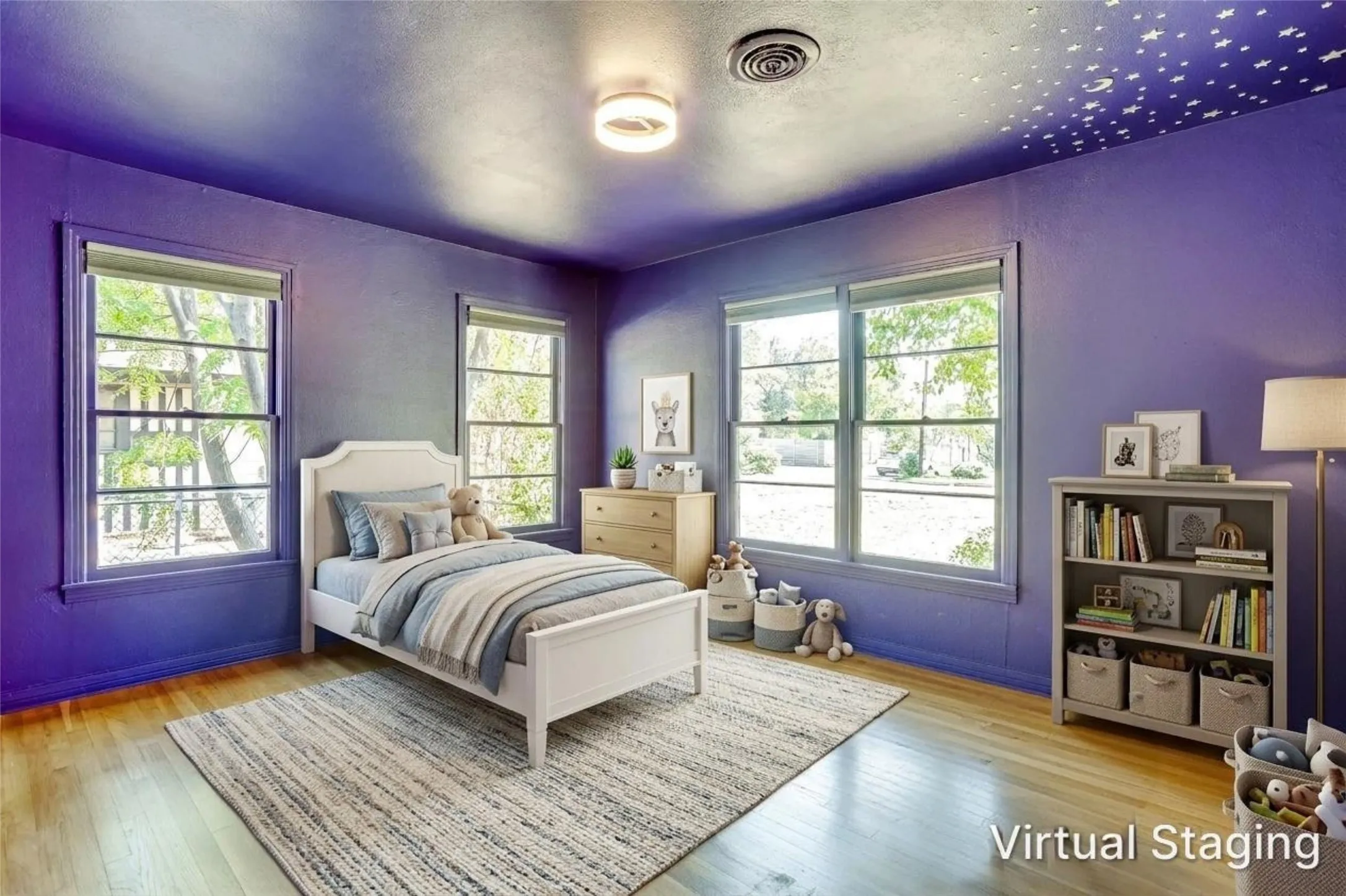 Wood-finish flooring, multiple windows providing natural light, a ceiling-mounted light fixture, and a decorative ceiling accent
